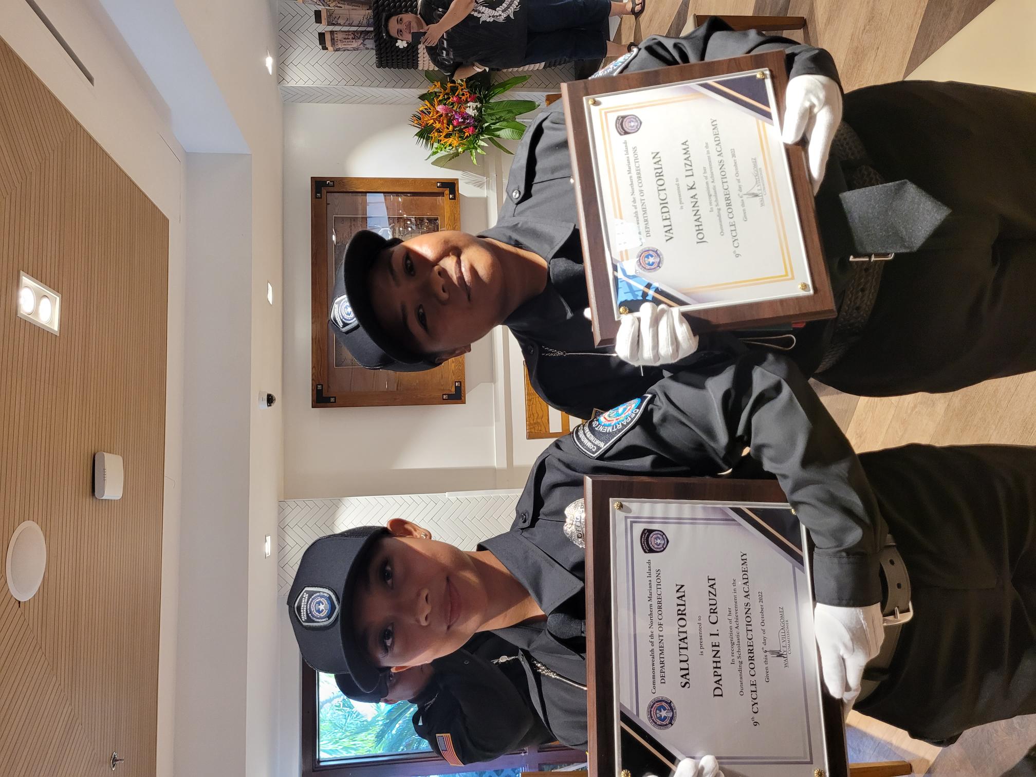 The 9th Cycle Corrections Academy salutatorian Daphne Idlisan Cruzat, left, and valedictorian Johanna Kapileo Lizama.