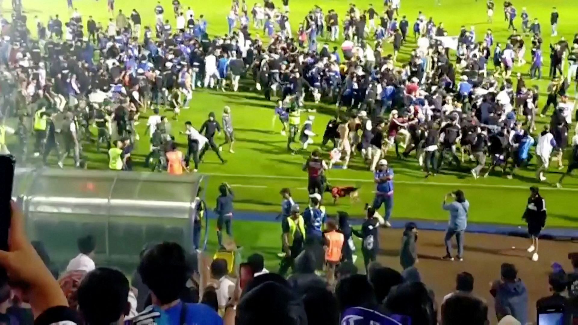 Fans invade the soccer field after a match between Arema FC and Persebaya Surabaya at Kanjuruhan Stadium, Malang, Indonesia. Oct 2, 2022 in this screen grab taken from a REUTERS video.