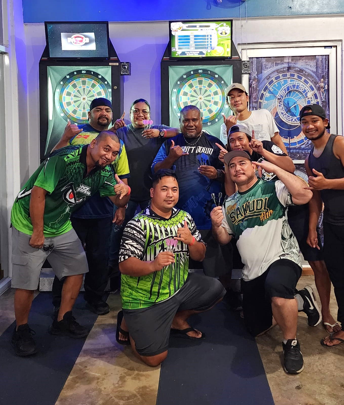 True North DLNR No Fear and  9 Eleven Marpac'ers Eagle pose for a photo during an inter-government division game of the SEDA Bud Light Dart League at Rendezvous Restaurant.