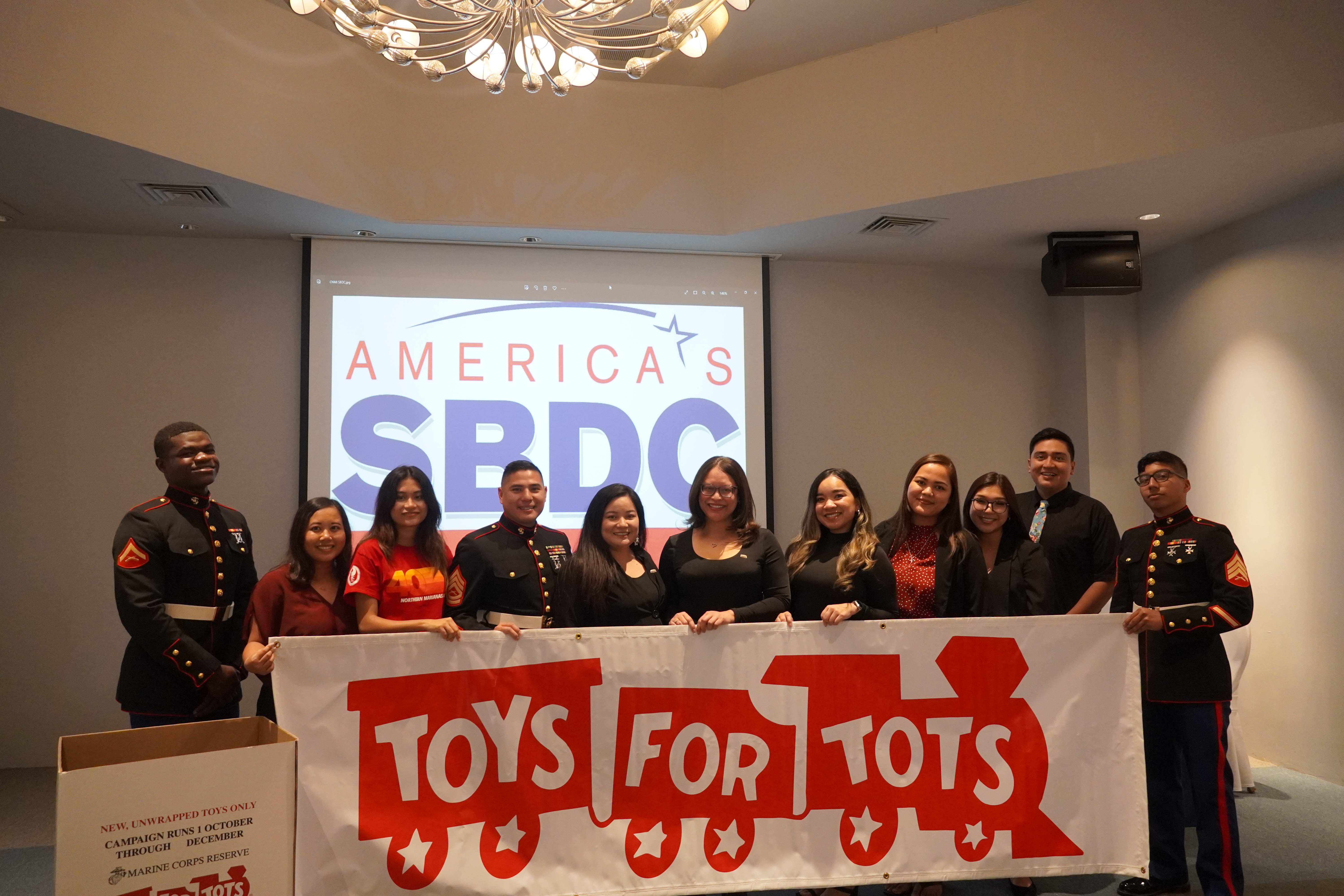 Members of the Saipan Chamber of Commerce pose for a photo with Marines from Marine Corps Base Camp Blaz.