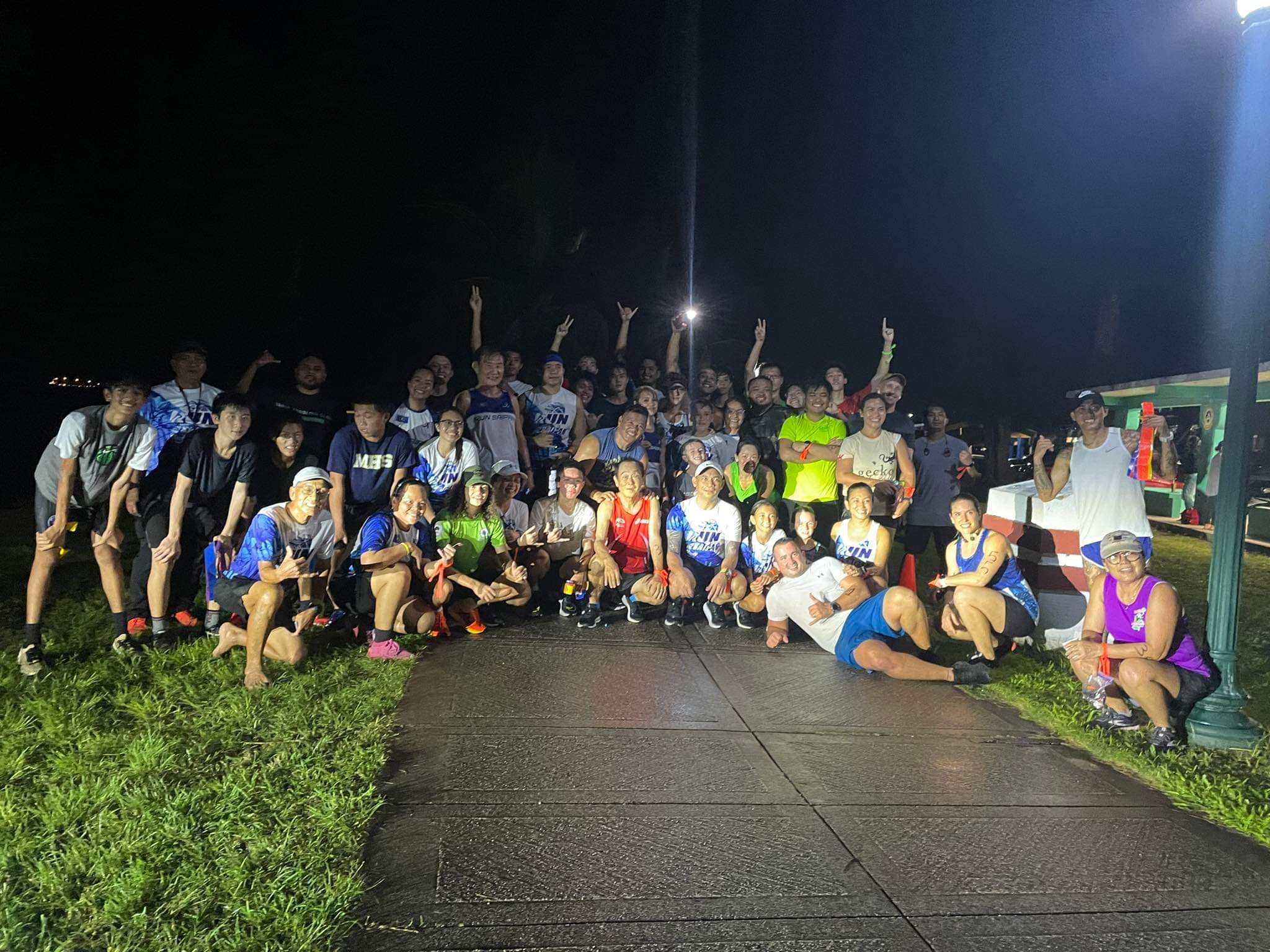 The Beach Road 5K race participants pose for a photo Friday evening.