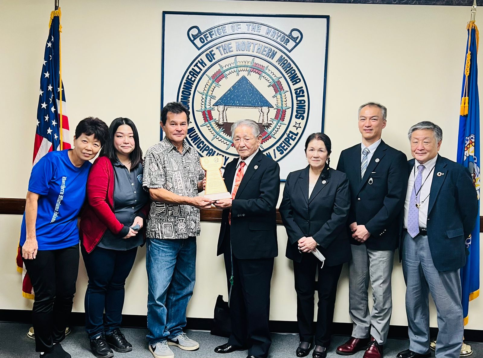 Kyowa Construction Chairman Noburu Hirayama, center, receives a plaque of appreciation from Henry Hofschneider the special assistant of Saipan Mayor David M. Apatang, at the Saipan Mayor's Office on Monday. Also in the photo are PDI's Hiroki Tajima, the Saipan Mayor's Office student exchange coordinator  Youki Kishimoto, Kyowa Construction's Noriko Ida, Katori Priest Shingo Katori and Kyowa Construction's Yoichi Matsumura.