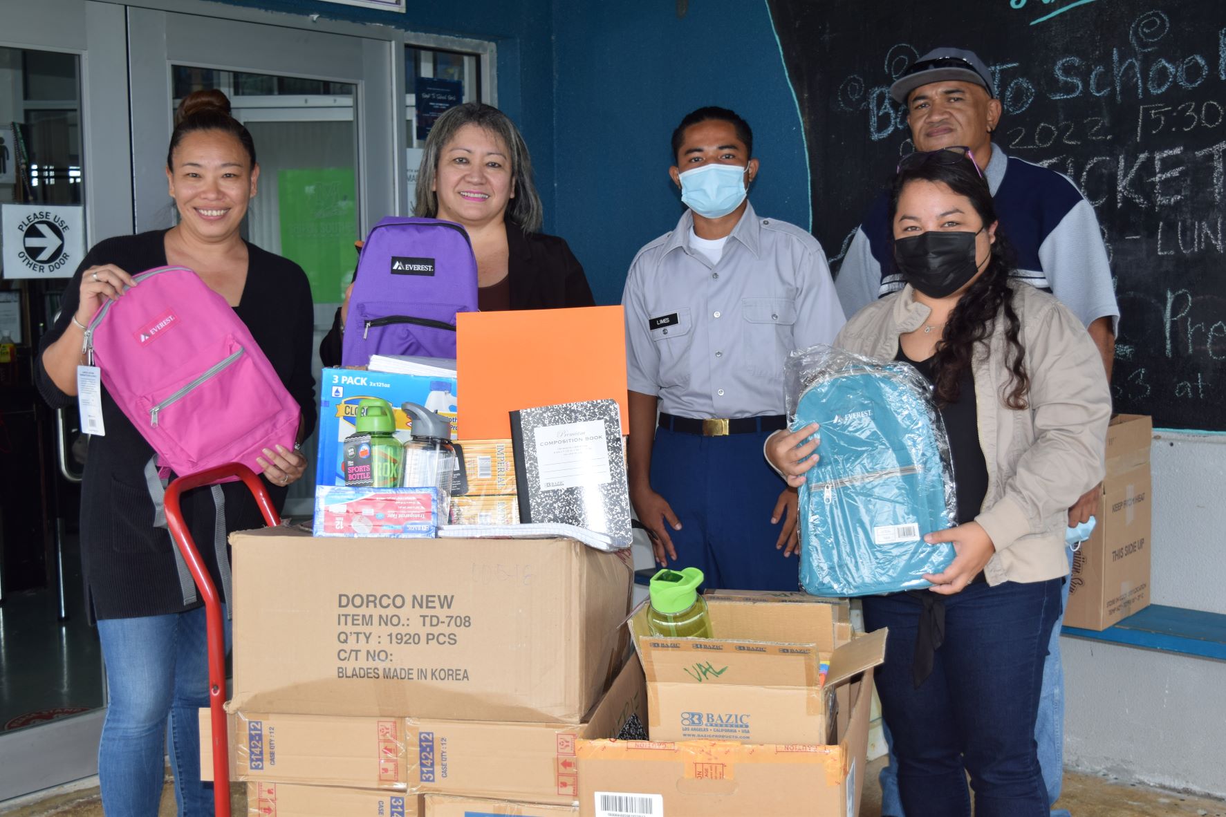 Sen. Edith Deleon Guerrero, second left, Saipan Southern High School Vice Principal Arisa Sakai Peters, left, a student and staff pose for a photo with the school supplies the lawmaker donated Thursday.