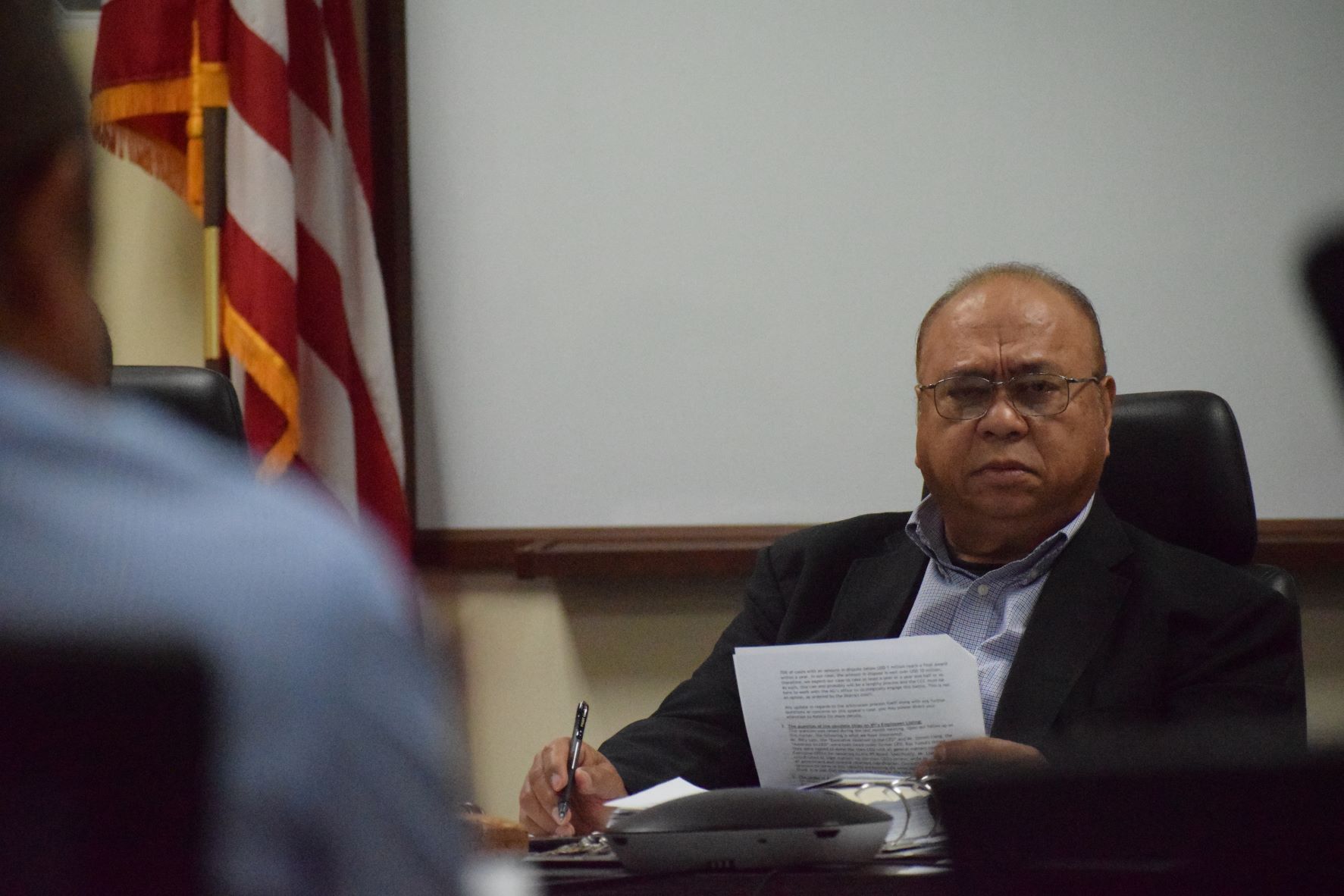 Commonwealth Casino Commission Chairman Edward C. Deleon Guerrero listens to the report of Commission Executive Director Andrew Yeom — back to the camera — during a meeting in the CCC’s conference room at Spring Plaza in Gualo Rai on Thursday.