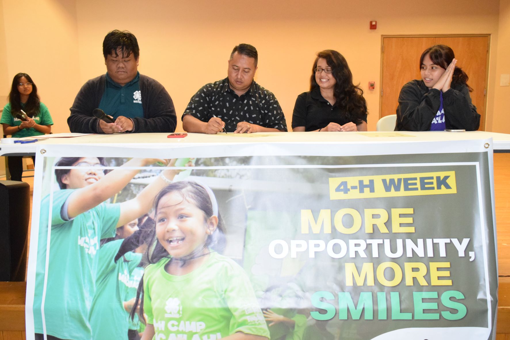 Gov. Ralph DLG Torres, second left, signs the proclamation designating Oct. 2 to 8, 2022 as National 4-H Week in the CNMI at the Kagman Community Center on Wednesday. Joining him are 4-H Marianas Youth State Council President Rownel Jody Coloma, left, 4-H Saipan Youth Council Vice President Raina Avelino, right, and Northern Marianas College-Cooperative Research, Extension and Education Services Interim Dean Patricia Coleman, second right.