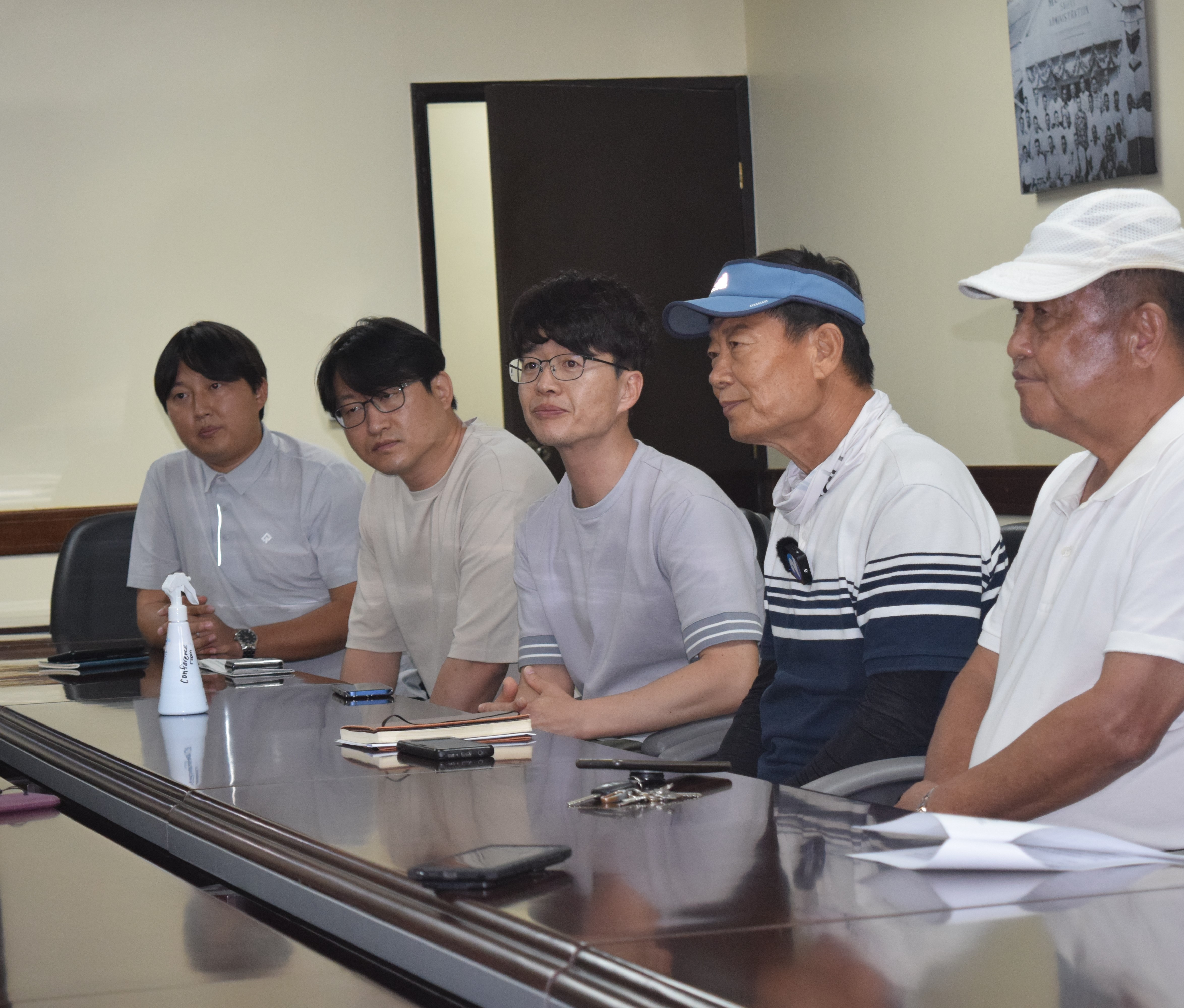 P&A Corp. owner Kim Hong Kyun, right, looks on as P&A manager Jonathan Joo, second right, talks to members of the media during a press conference at the Saipan Mayor's Office on Thursday. Also in photo are the other members of the organizing committee of the 2022 Saipan Tourism Fanival-U.S.-Korea Friendship K-Pop Concert which was canceled.