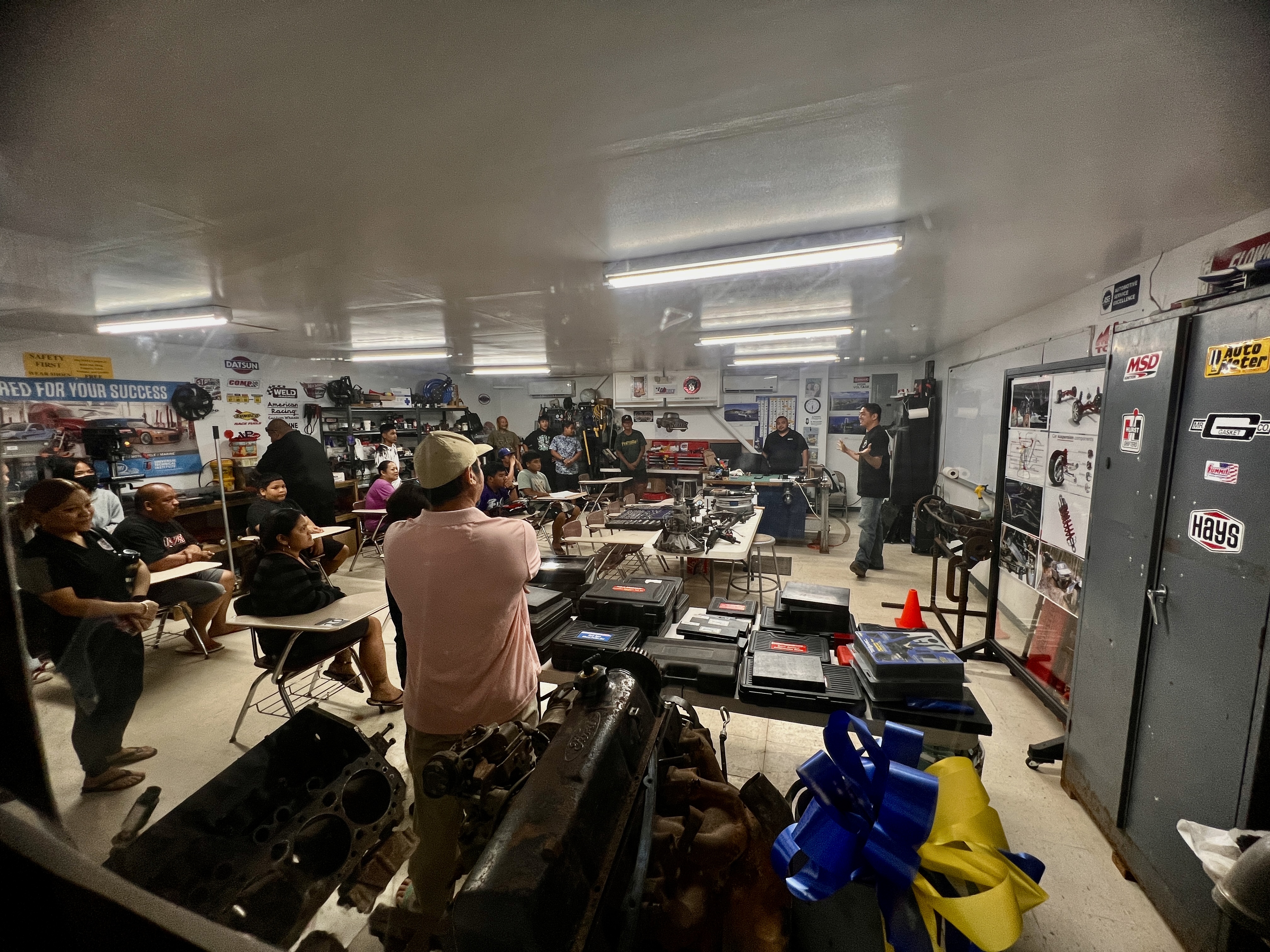 NMTech automotive technology instructor Dante Yumul introduces Tanapag Middle School students and parents to his class.