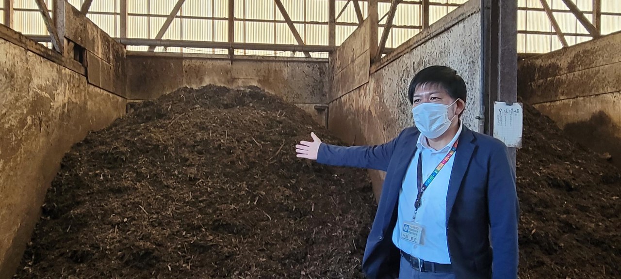 Osaki Town Office Resident and Environment Division assistant section chief and Environmental Measures Section manager Shizuto Takehara shows fermenting compost at the town's composting facility.
