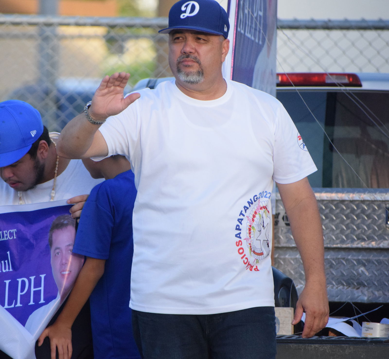 Rep. Ralph N. Yumul participate in a road-waving activity on Beach Road in San Jose earlier this month.