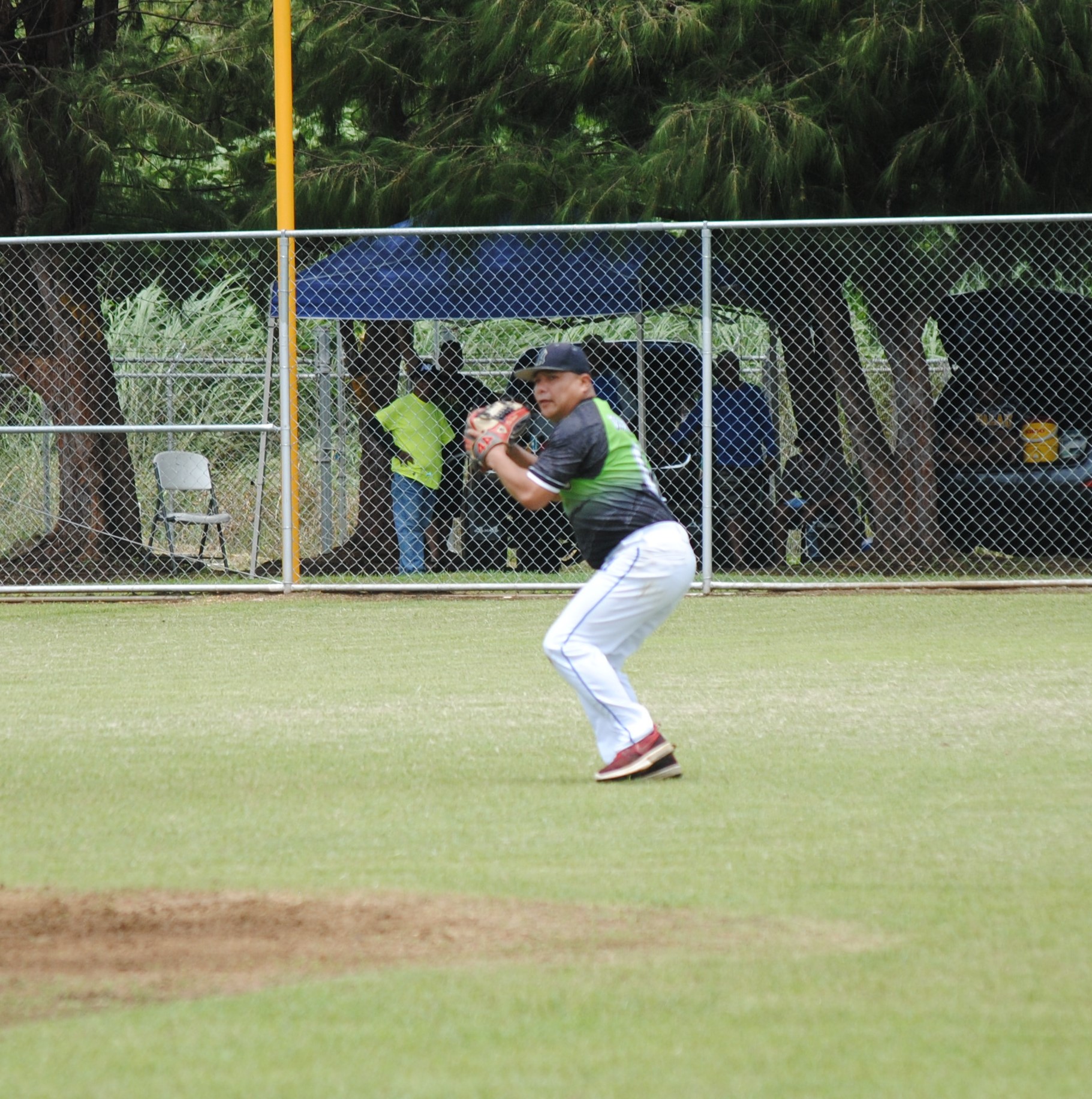 Tokahao shortstop Jerome Delos Santos gathers for the throw to first for an out during a 2022 Budweiser Belau Amateur Softball League game at the Dandan baseball field.