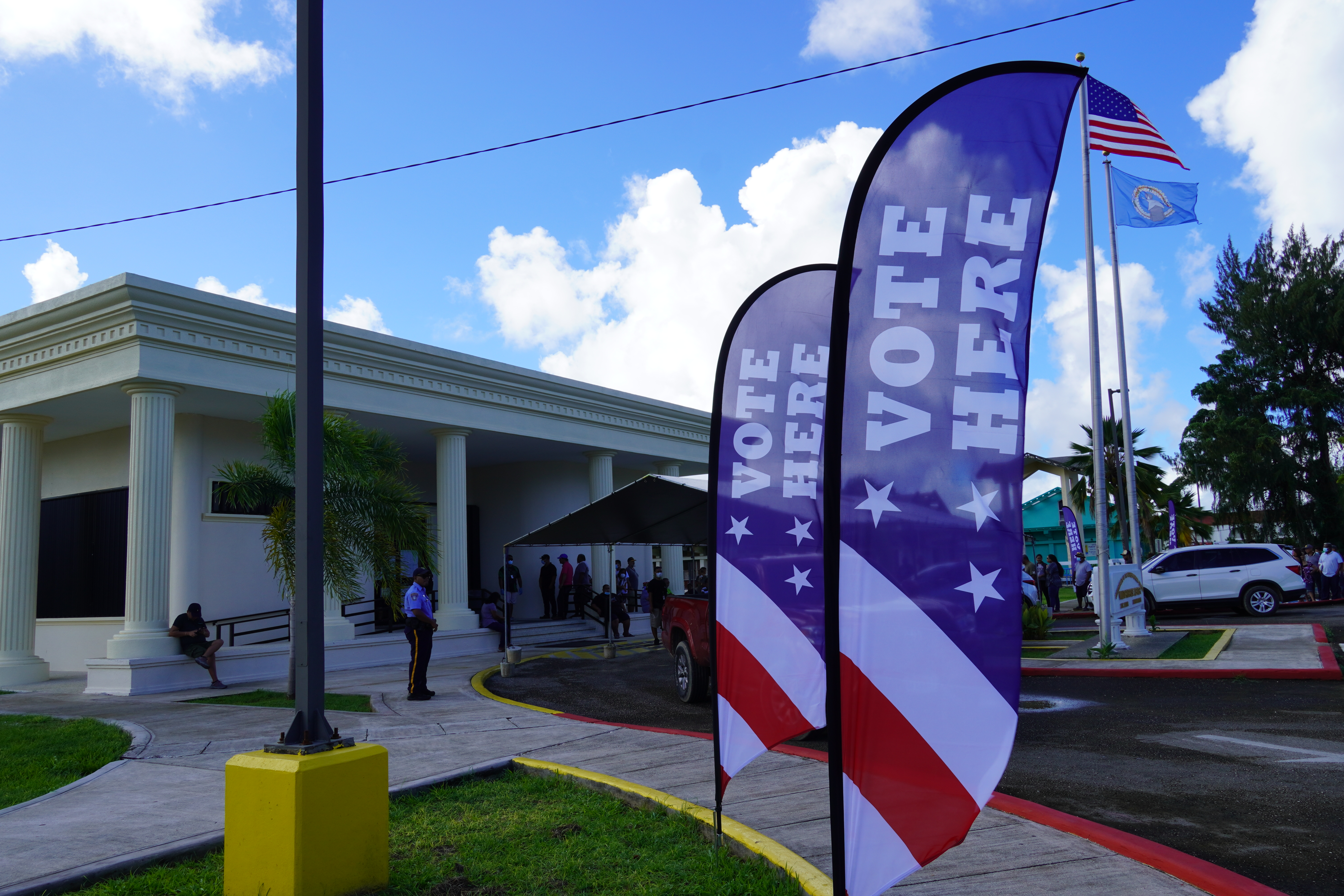 Curbside banners encouraging people to vote are seen outside the Gov. Pedro P. Tenorio Multi-Purpose Center in Susupe on Tuesday.