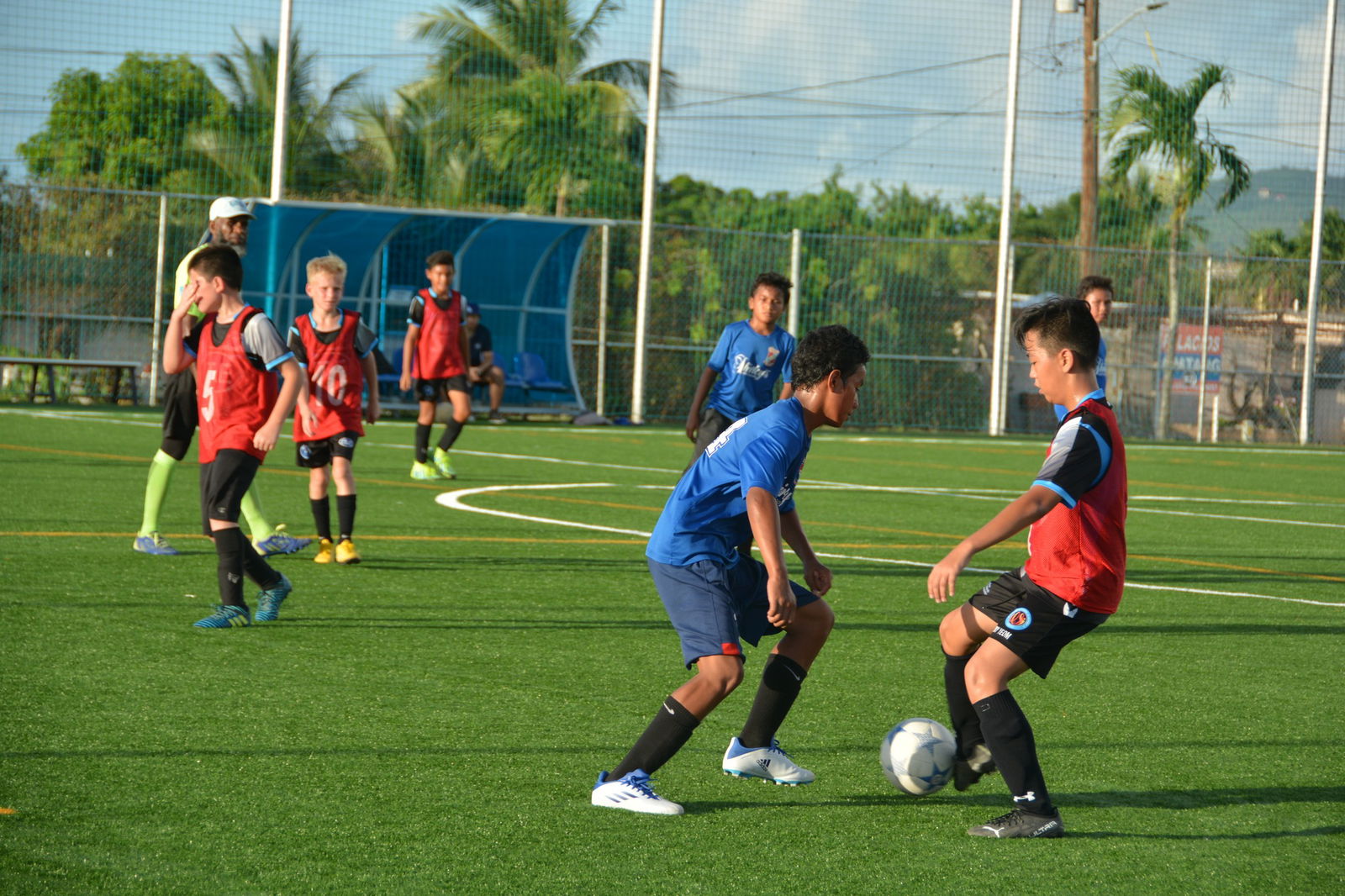 MP United Blue's Riku Takahashi tries to outmaneuver a Shirley’s defender during a U13 Boys Division game of the 2022 Fall TakeCare Youth Soccer League Saturday at the NMI Soccer Training Center.