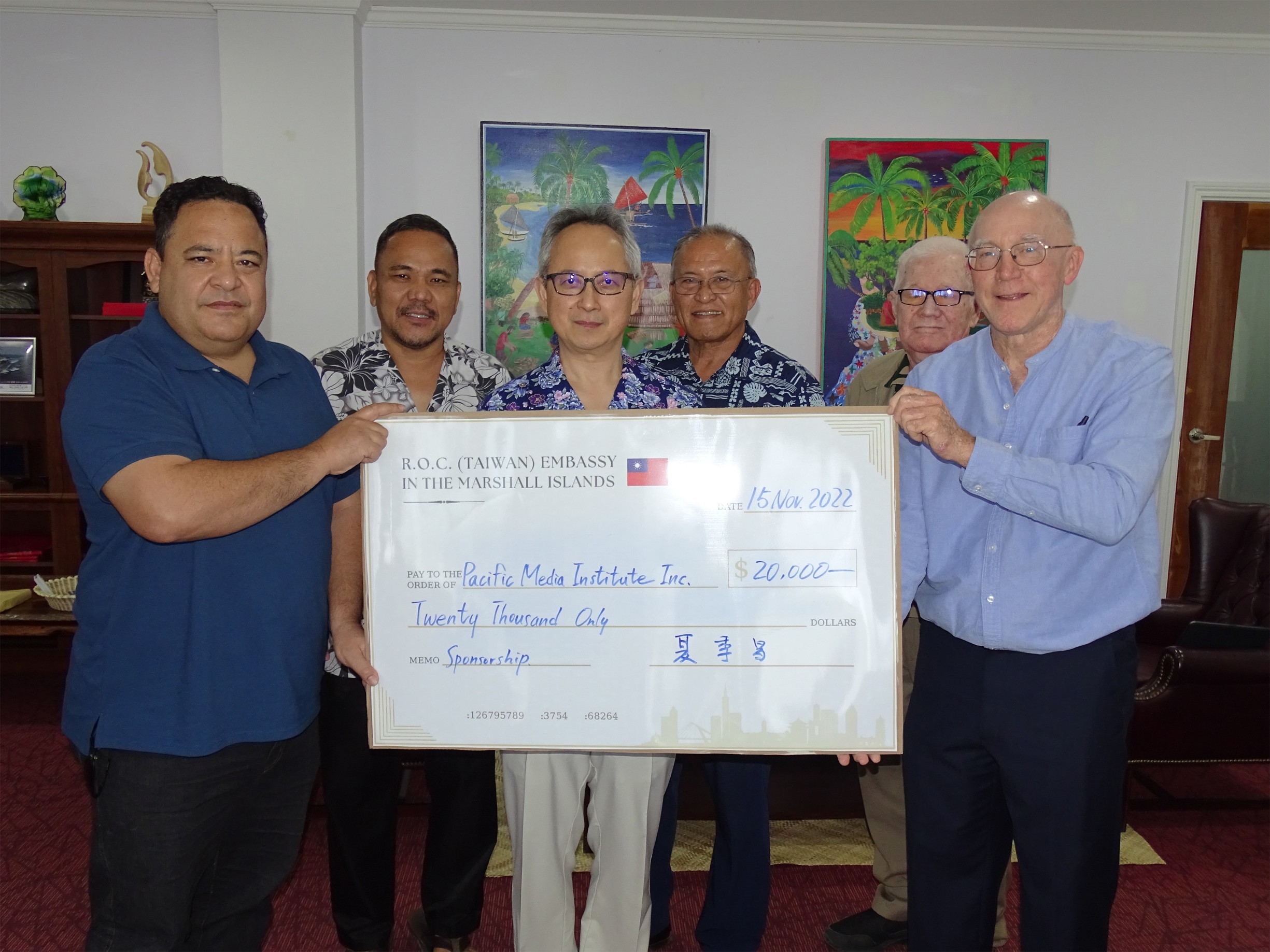 Taiwan Ambassador to the Marshall Islands Steve C.C. Hsia, center, presents a $20,000 check in support of a Summit on Democracy  to be held in Majuro early next year to representatives of the Paciﬁc Media Institute Daniel Kramer, led, and Giﬀ Johnson. Joining them in support of the initiative are, from left back: Nitijela Speaker Kenneth Kedi, President David Kabul, and presidential advisor Fred J. Pedro.