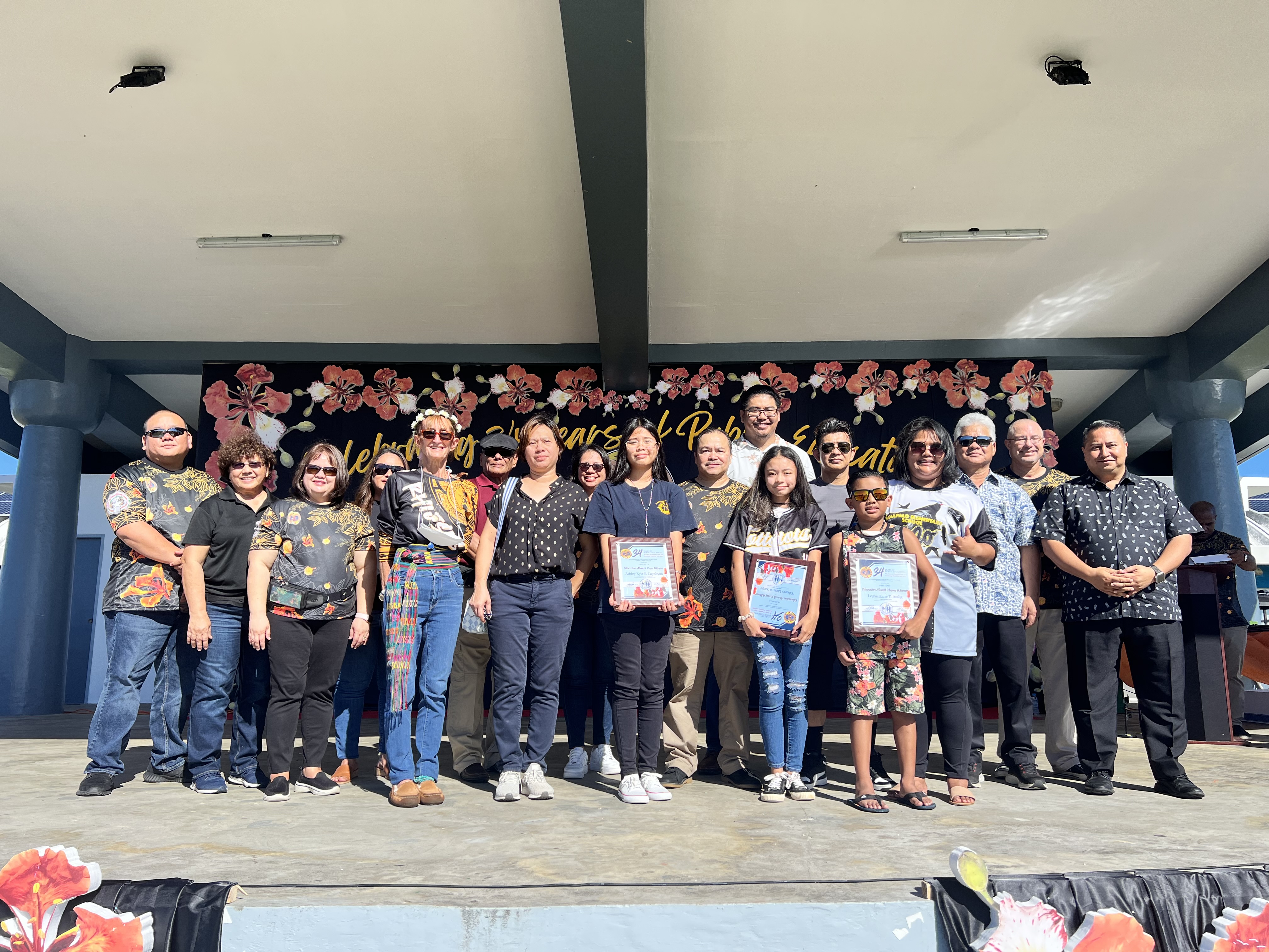 Education Month Theme Winner Logan Zane T. Atalig (4th grade, Sinapalo Elementary School), Education Month Logo Winner Ashley Kyle E. Cayabyab (10th grade, Dr. Rita Hocog Inos Junior Senior High School), and Education Month Essay winner Ysharei Lizama Sanje (8th grade, Dandan Middle School) pose for a photo with  Gov. Ralph DLG Torres, Lt. Gov. Arnold I. Palacios, Commissioner of Education Dr. Alfred B. Ada, Associate Commissioner Eric Magofna, Board of Education Chairman Gregory Pat Pat Borja, BOE Vice Chairman Antonio L. Borja, BOE Secretary/Treasurer Maisie B. Tenorio, BOE Member Herman Atalig, PSS Senior Directors Jackie Quitugua, Dr. Rizalina Liwag and Dr. Yvone Pangelinan, parents and school administrators.