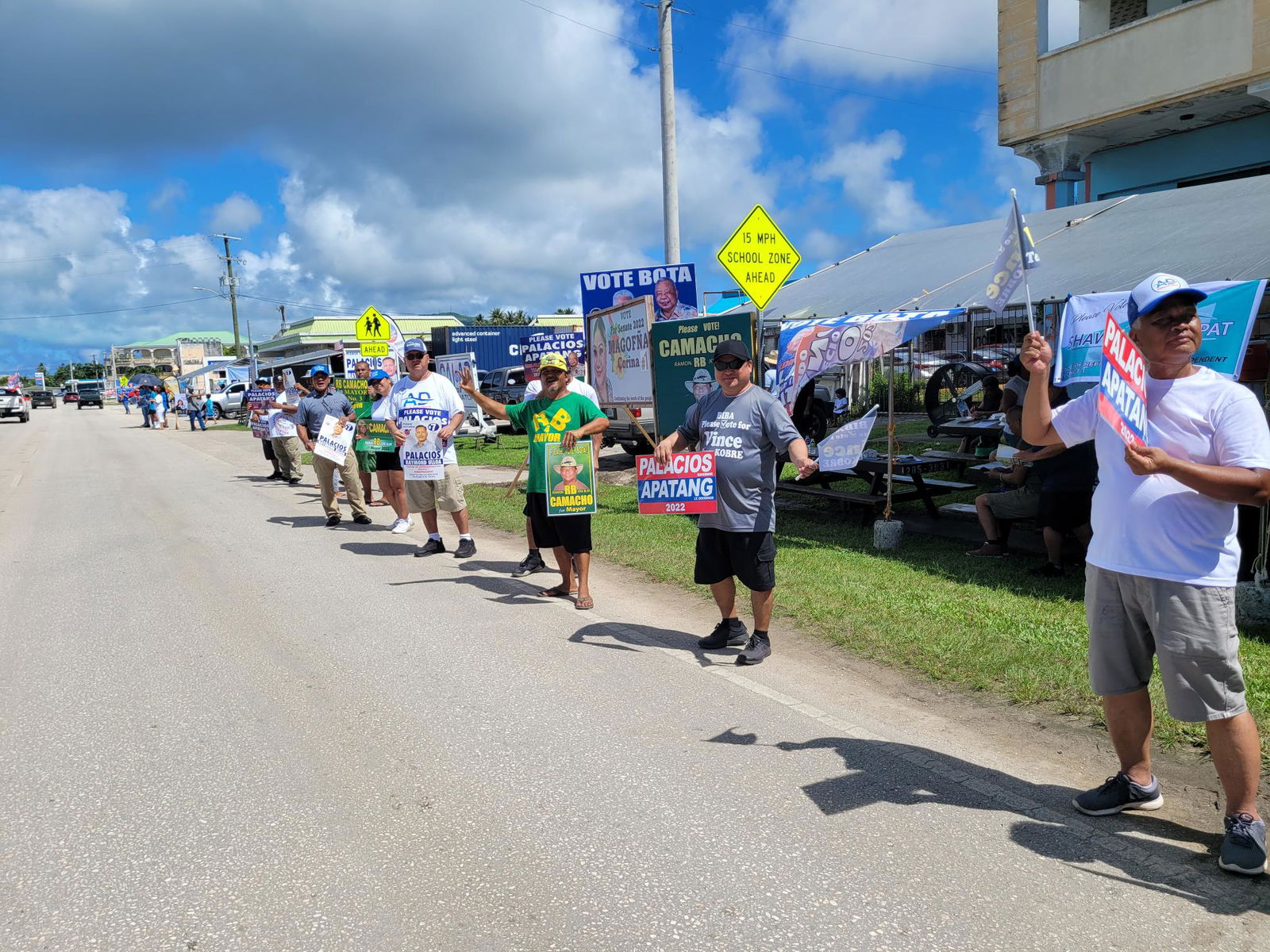 The AD 2022 Independent slate supporters wave at motorists across from Hopwood Middle School on Tuesday.