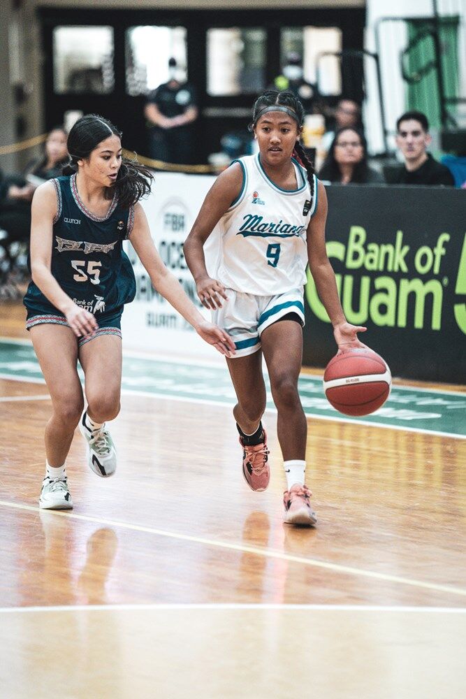 The NMI's Kaithlyn Chavez dribbles forward as Guam's Maria-Jean Paulino closes in during a FIBA U15 Women's Oceania Championship game on Monday in Mangilao, Guam.