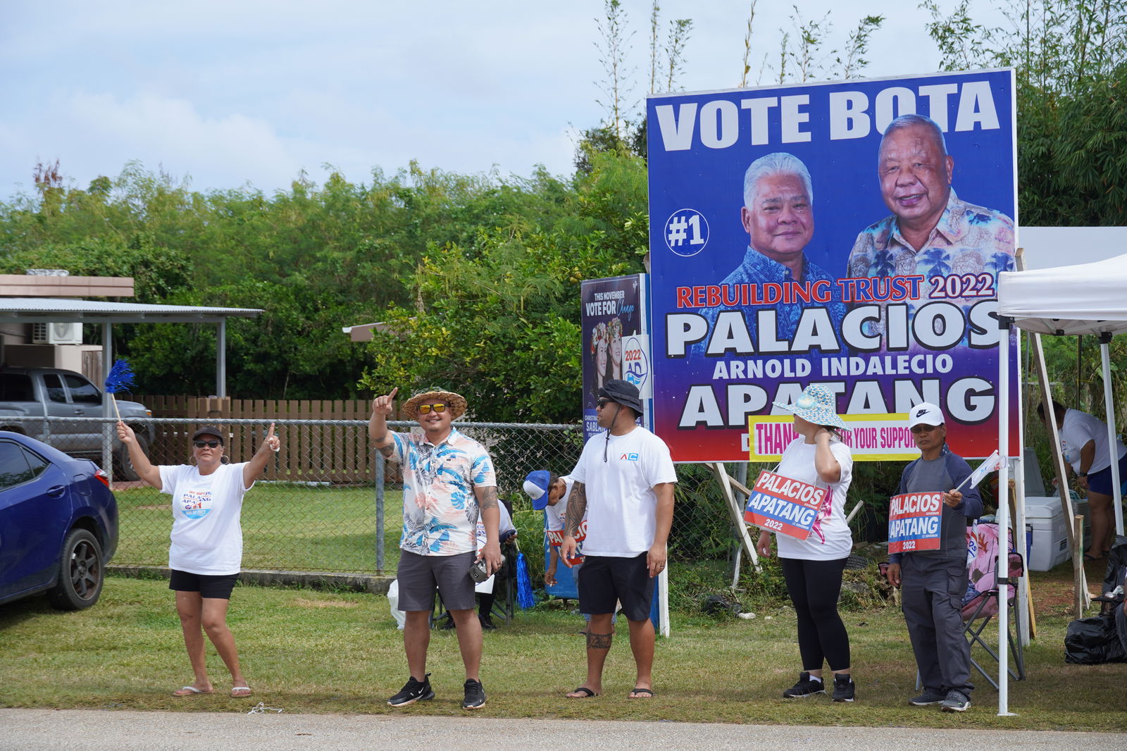 Precinct 5 Rep.-elect Angelo A. Camacho, second left, is among the Independent supporters waving at passersby in Kagman.