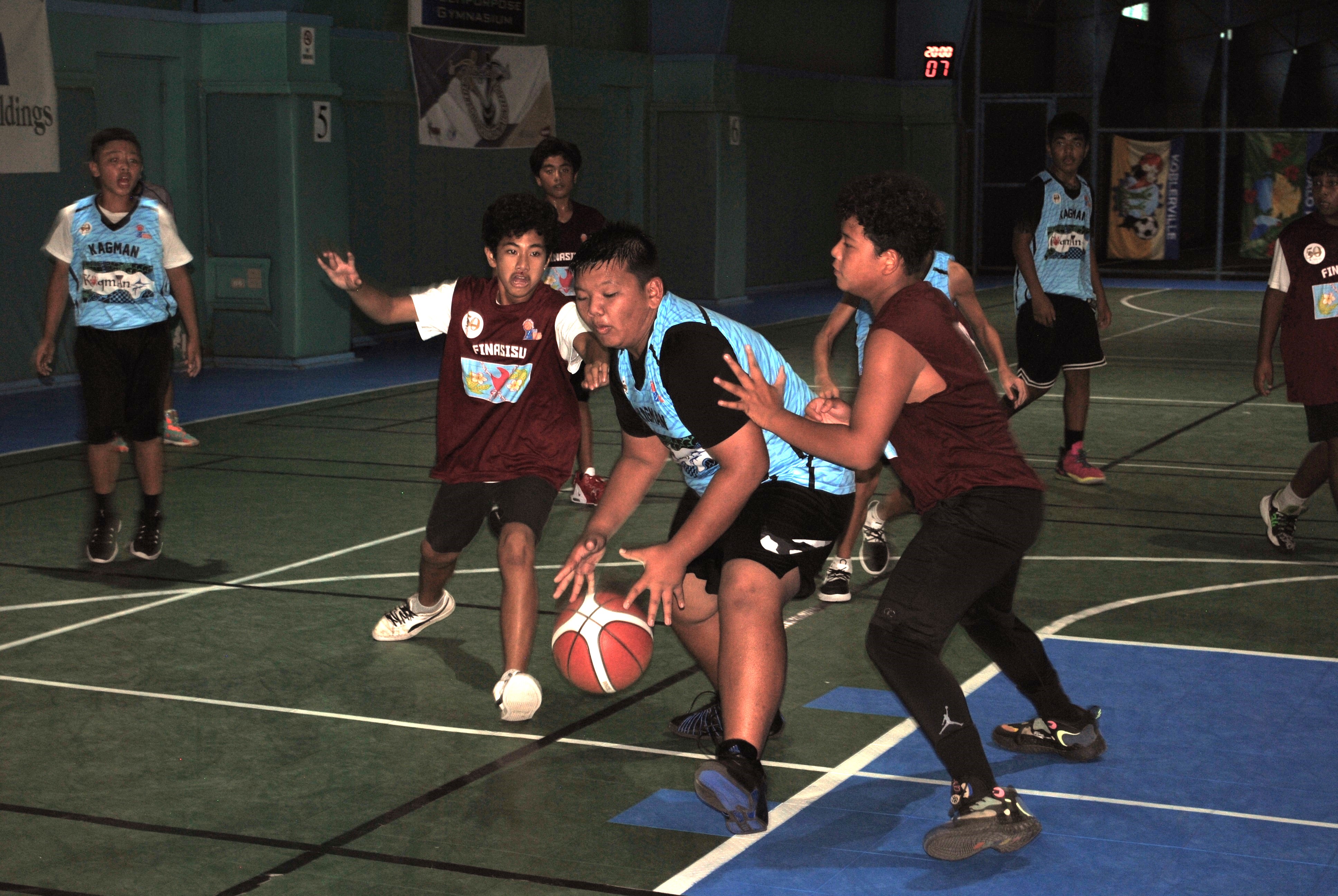 Kagman's David Apatang protects the ball as he gathers for the shot inside the paint during a U13 boys division game of the 2022 Marianas Village Pride Basketball League Saturday at the TSL Sports Complex.