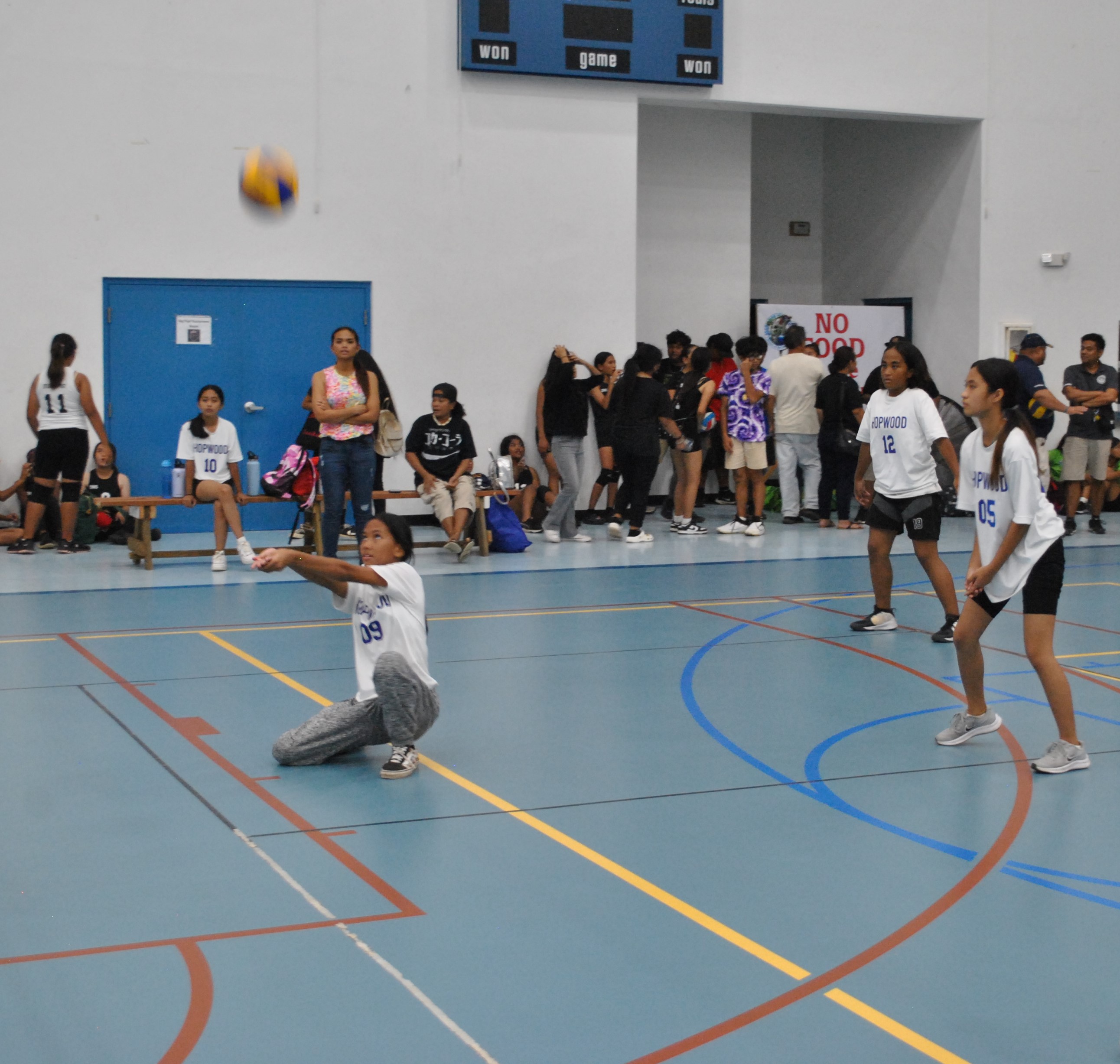 A Hopwood Middle School JV player kneels for the bump return during a girls middle school volleyball game Thursday at the MHS gym.
