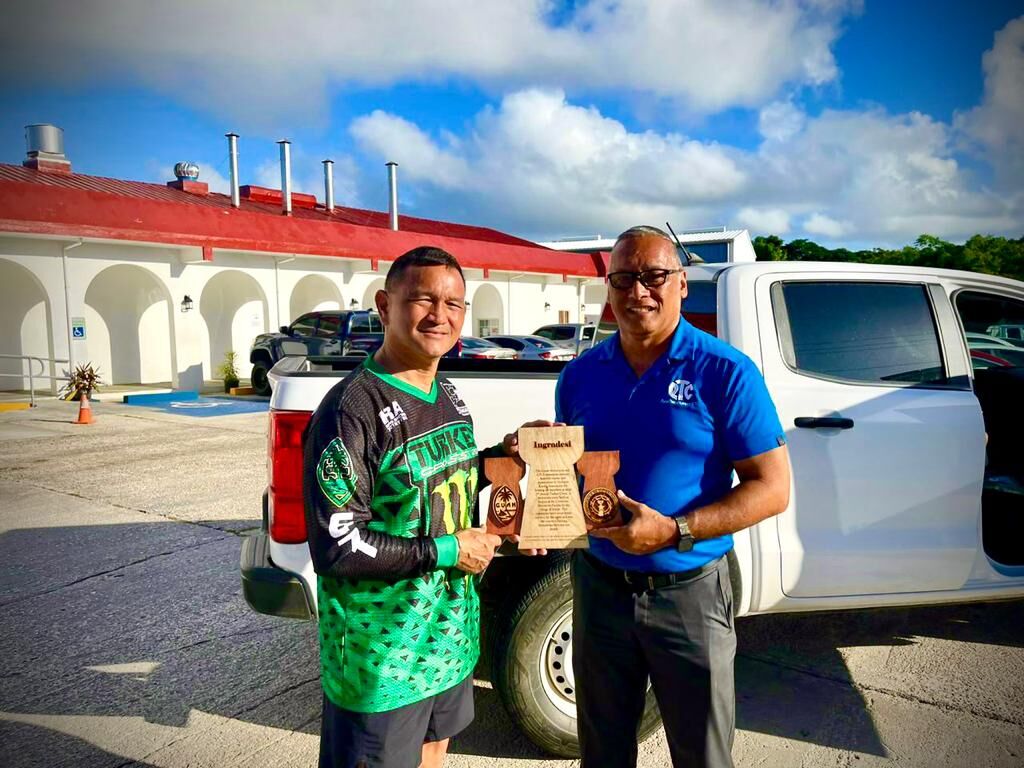 Guam Motorcycle and ATV Corporation President Jeff Rios and Marianas Racing Association President Charles Cepeda pose with the “Thank You” trophy.
