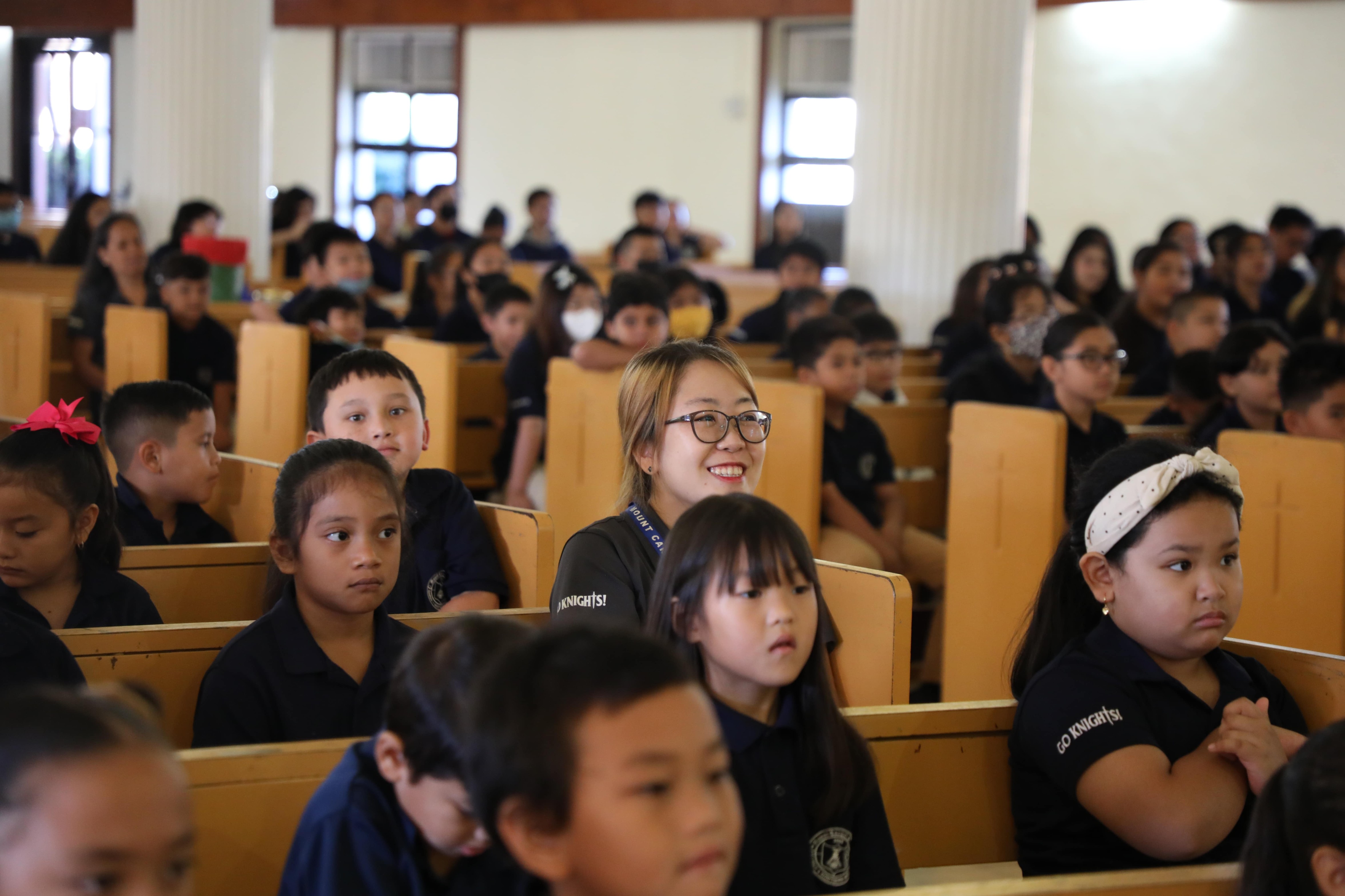 The Mount Carmel School community listens to Father Ken Masong's homily during the recent Thanksgiving Mass.