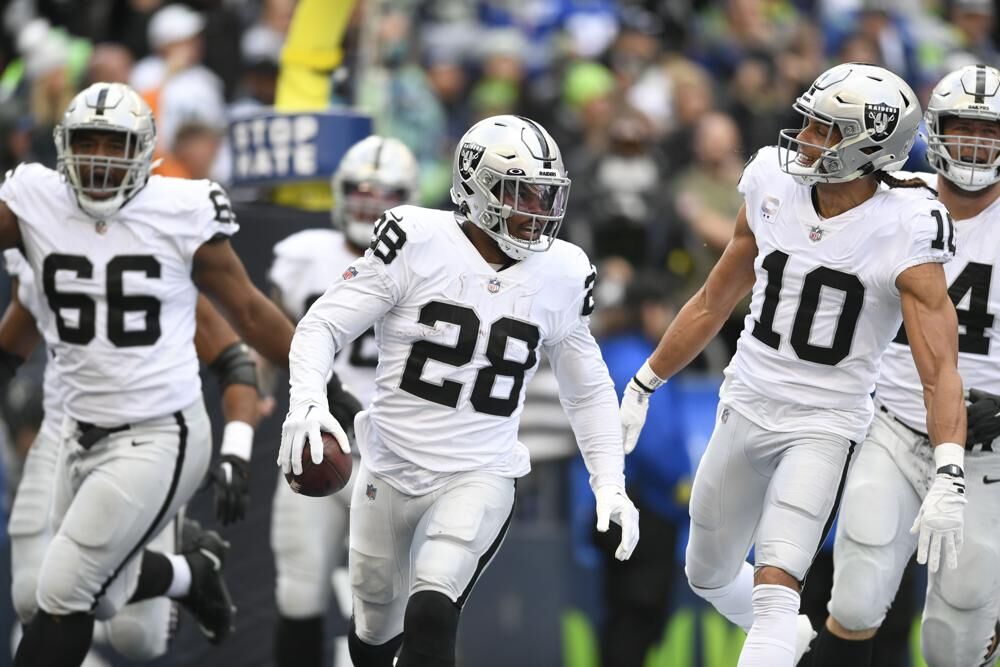 Las Vegas Raiders running back Josh Jacobs (28) celebrates after scoring a touchdown during the first half of an NFL football game against the Seattle Seahawks Sunday, Nov. 27, 2022, in Seattle.