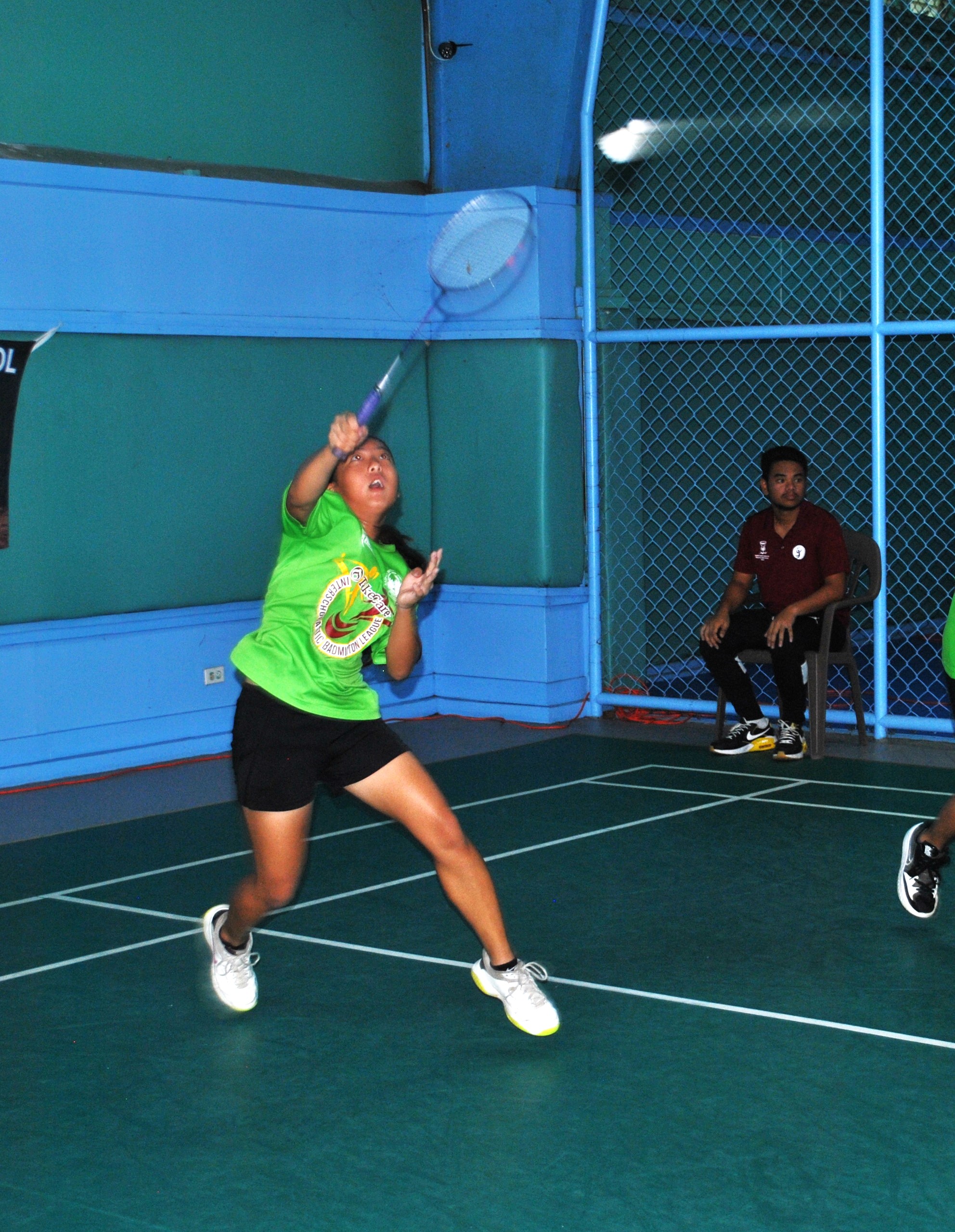 SIS' Lina Tsukagoshi connects the overhand return during a mixed doubles event of the middle school division championship of the TakeCare Interscholastic Badminton League at the TSL Sports Complex on Saturday.