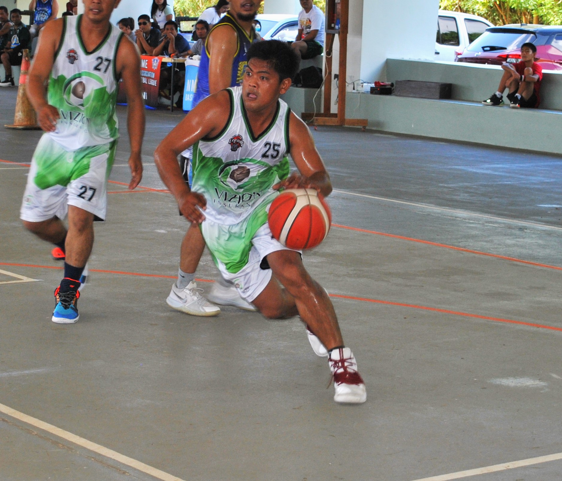 Vizion's Rodel Pastrana drives toward the hoop during an open division game of the 2022 Legends Sports Association Invitational Basketball League Sunday at the Koblerville gym.