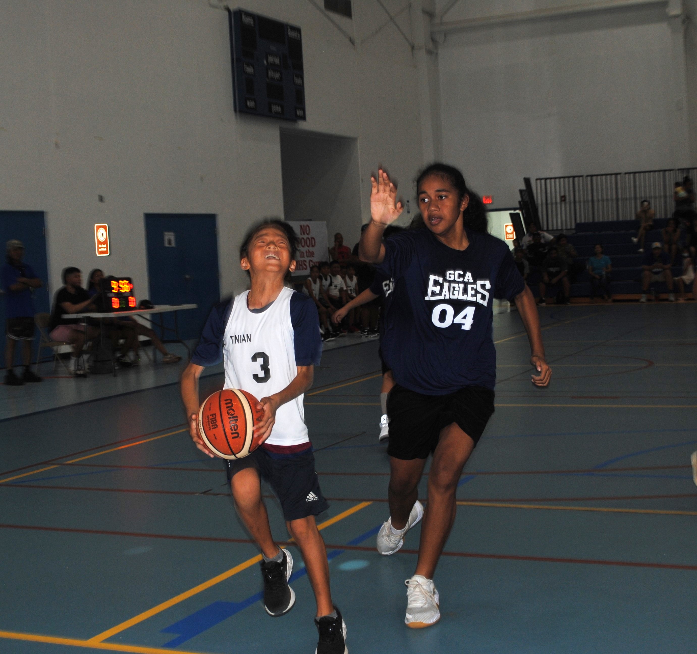 Tinian's Jun Young Seo gathers for the layup during an elementary school division game of the IT&E Interscholastic Basketball League on Saturday at the MHS gym.