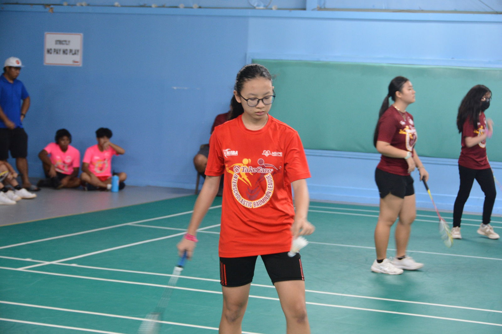 An Agape player sets up for a serve during a NMBF-PSS Co-ed Middle School Badminton League game at the TSL Sports Complex.