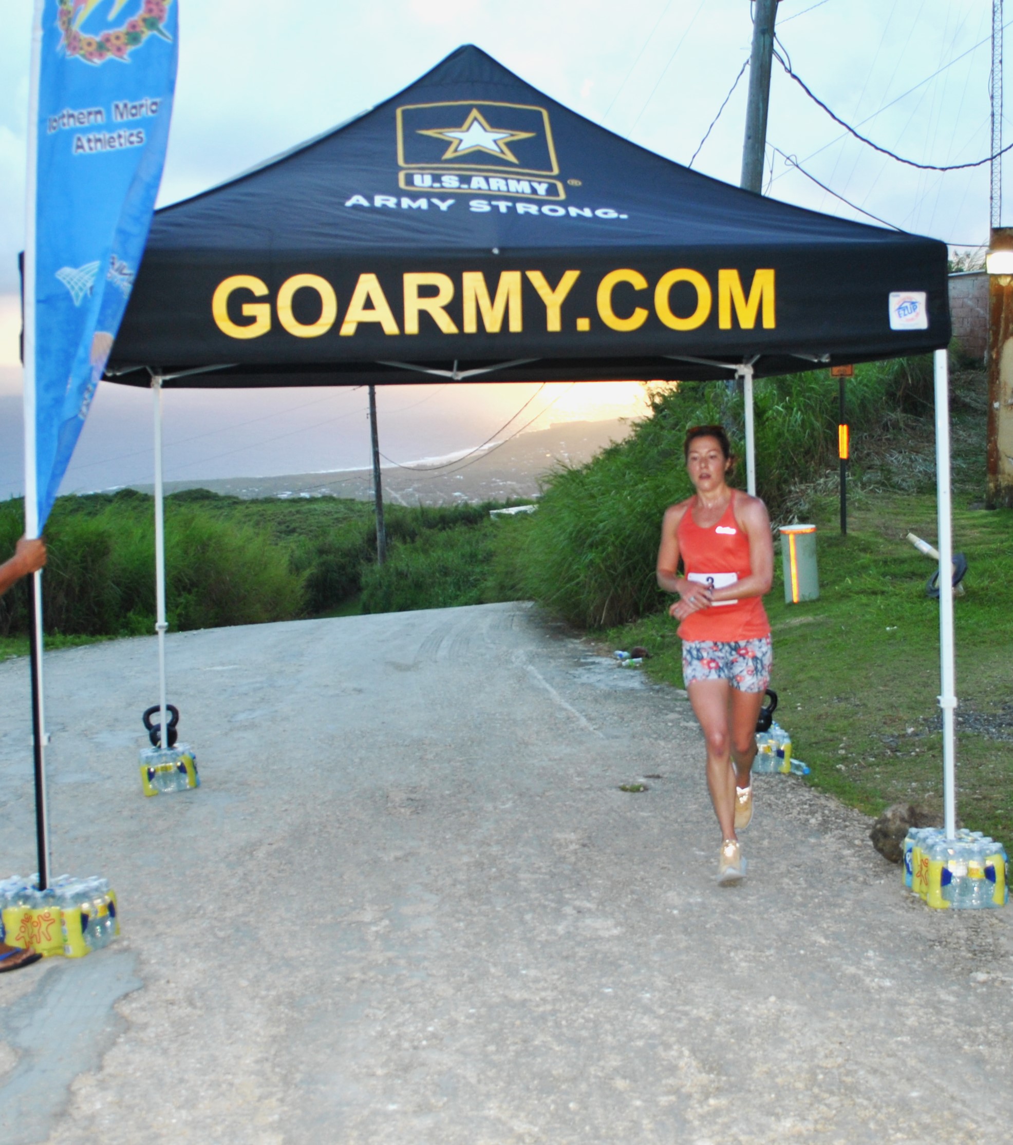 Kate Leugers checks her time after completing the NMA Mt. Tapochao Turkey Trot 2022 Thursday at Mt. Tapochao.