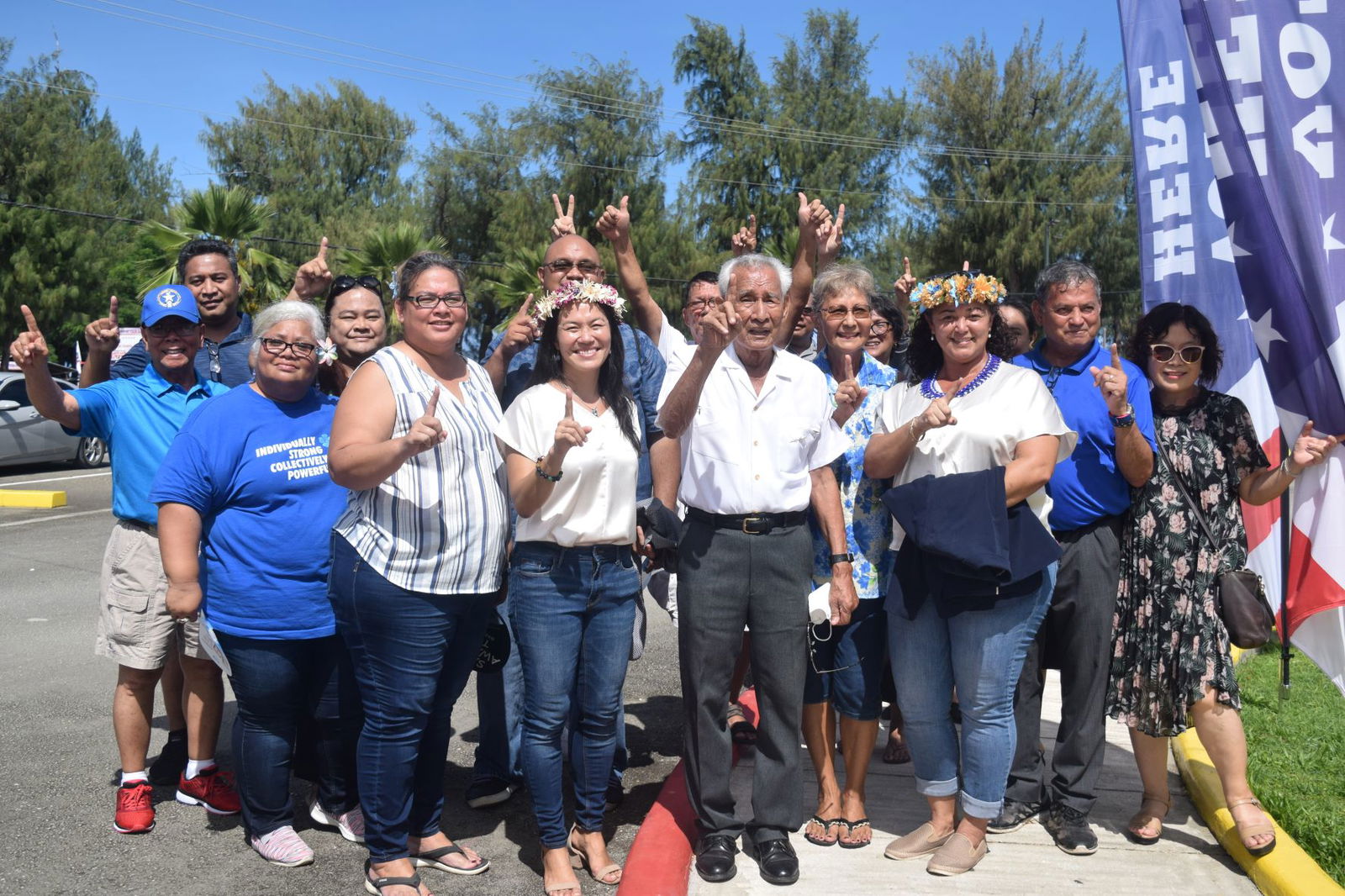NMI Democratic gubernatorial candidate Rep. Tina Sablan, fourth left, and running mate, Rep. Leila Staffler, third right, flash the no. 1 sign while posing for  a photo with the CNMI’s first governor, Dr. Carlos S. Camacho, center, former first lady Winnie Camacho and other supporters before heading to the multi-purpose center in Susupe to cast their early votes on Citizenship  Day, Friday, Nov. 4, 2022