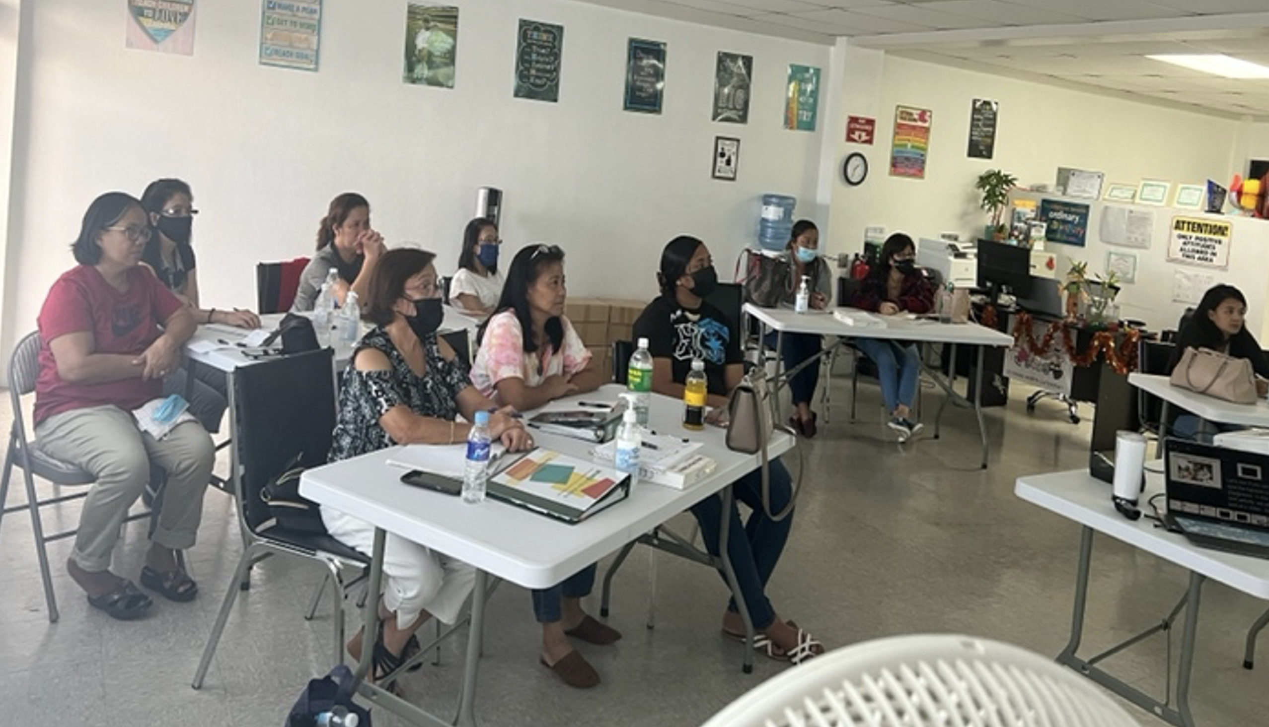 Child care providers participate in a training session on the health and safety of children.