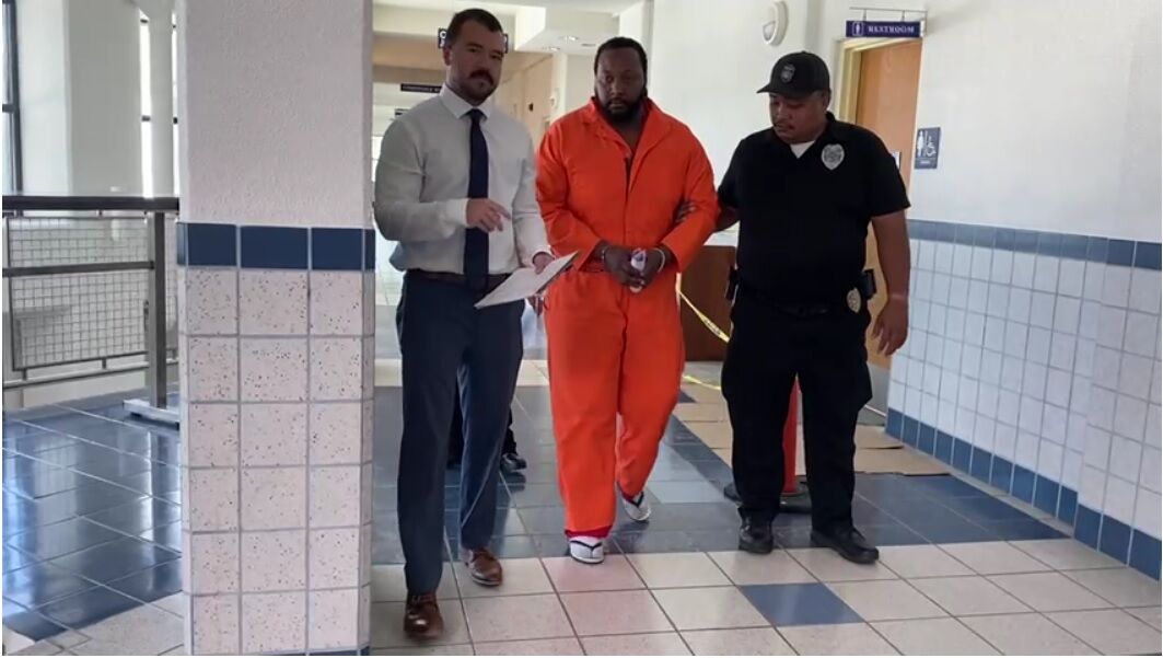 Willie Frink, center, with Assistant Public Defender Tyler Scott, left, following a bail hearing in Superior Court on Monday.