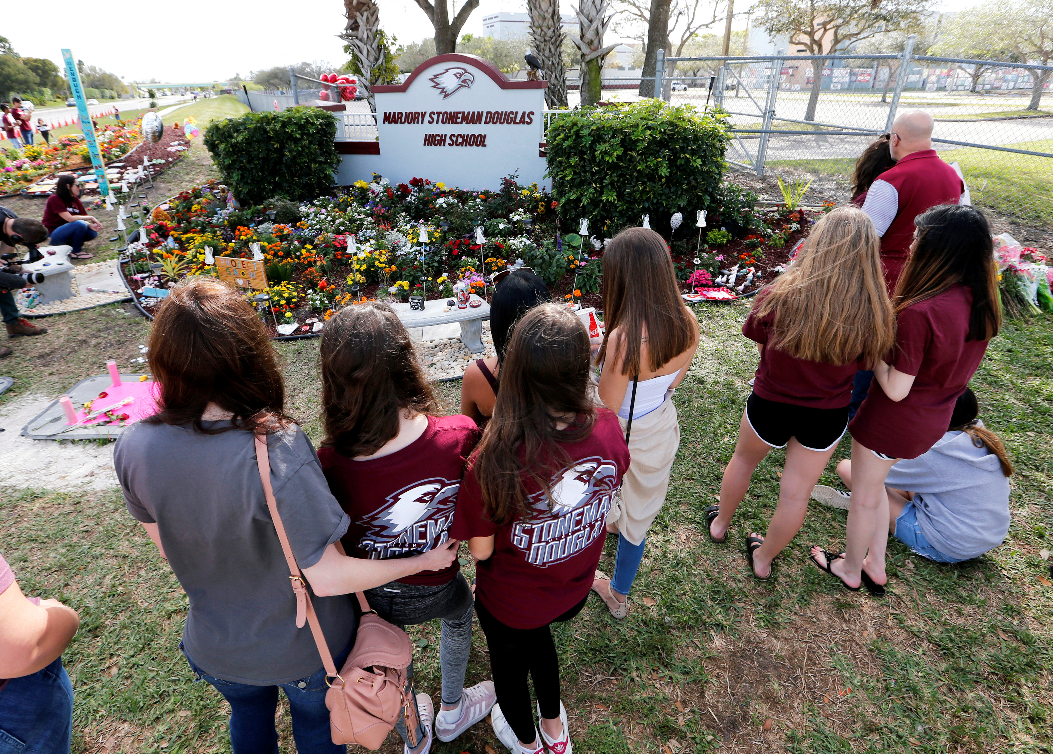 A memorial is viewed by parents and students on campus at a memorial on the one year anniversary of the shooting which claimed 17 lives at Marjory Stoneman Douglas High School in Parkland, Florida, Feb. 14, 2019.