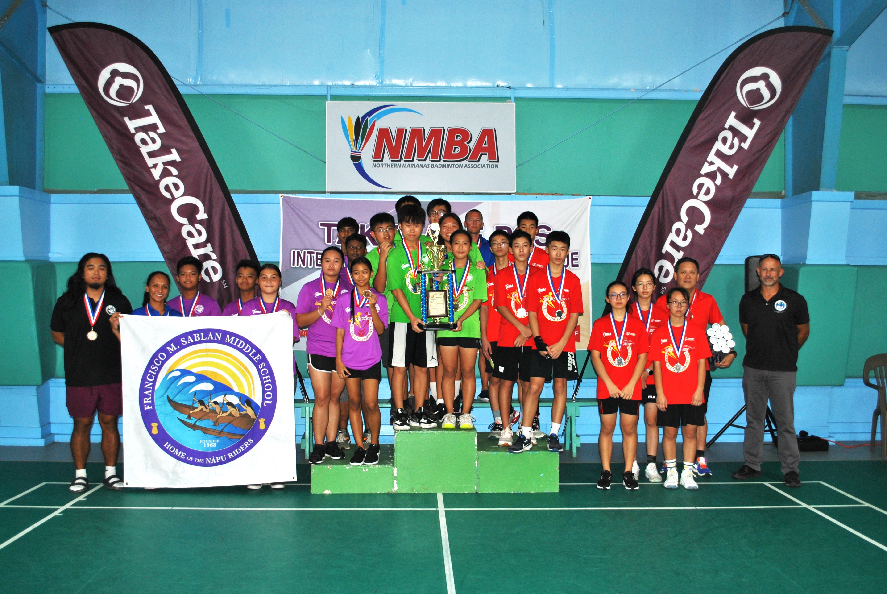 The top three schools pose with their trophies and medals during the award ceremony for the middle school division of the TakeCare Interscholastic Badminton League Saturday at the TSL Sports Complex. SIS edged Agape to win the title while Francisco M. Sablan Middle School finished third.