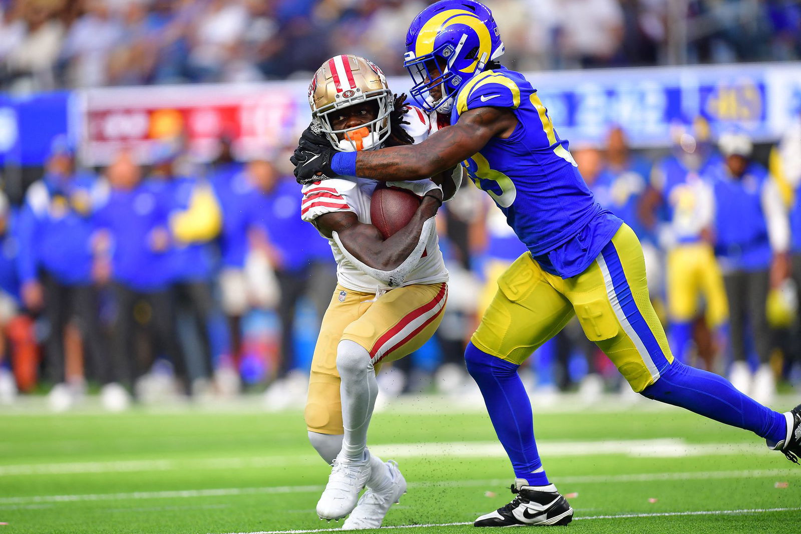 San Francisco 49ers wide receiver Brandon Aiyuk (11) runs the ball against Los Angeles Rams safety Nick Scott (33) during the second half at SoFi Stadium in Inglewood, California on Oct 30, 2022.