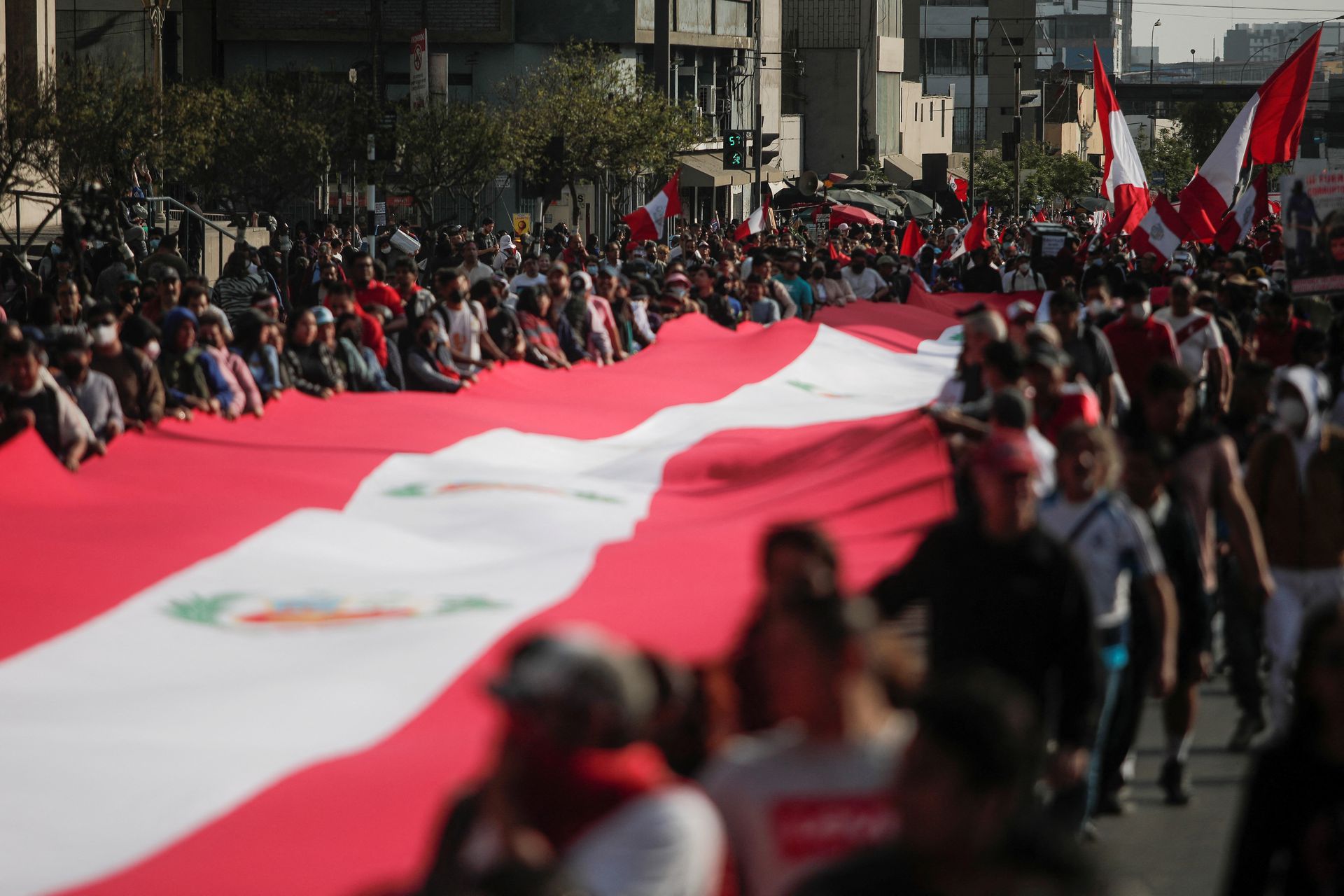 People carry a Peruvian flag, during a protest against the government of President Pedro Castillo, in Lima, Peru, Nov. 5, 2022.