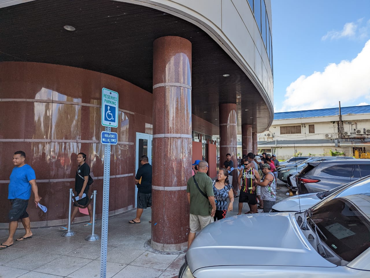 BOOST program applicants form a line outside the Bank of Saipan building in Chalan Laulau.