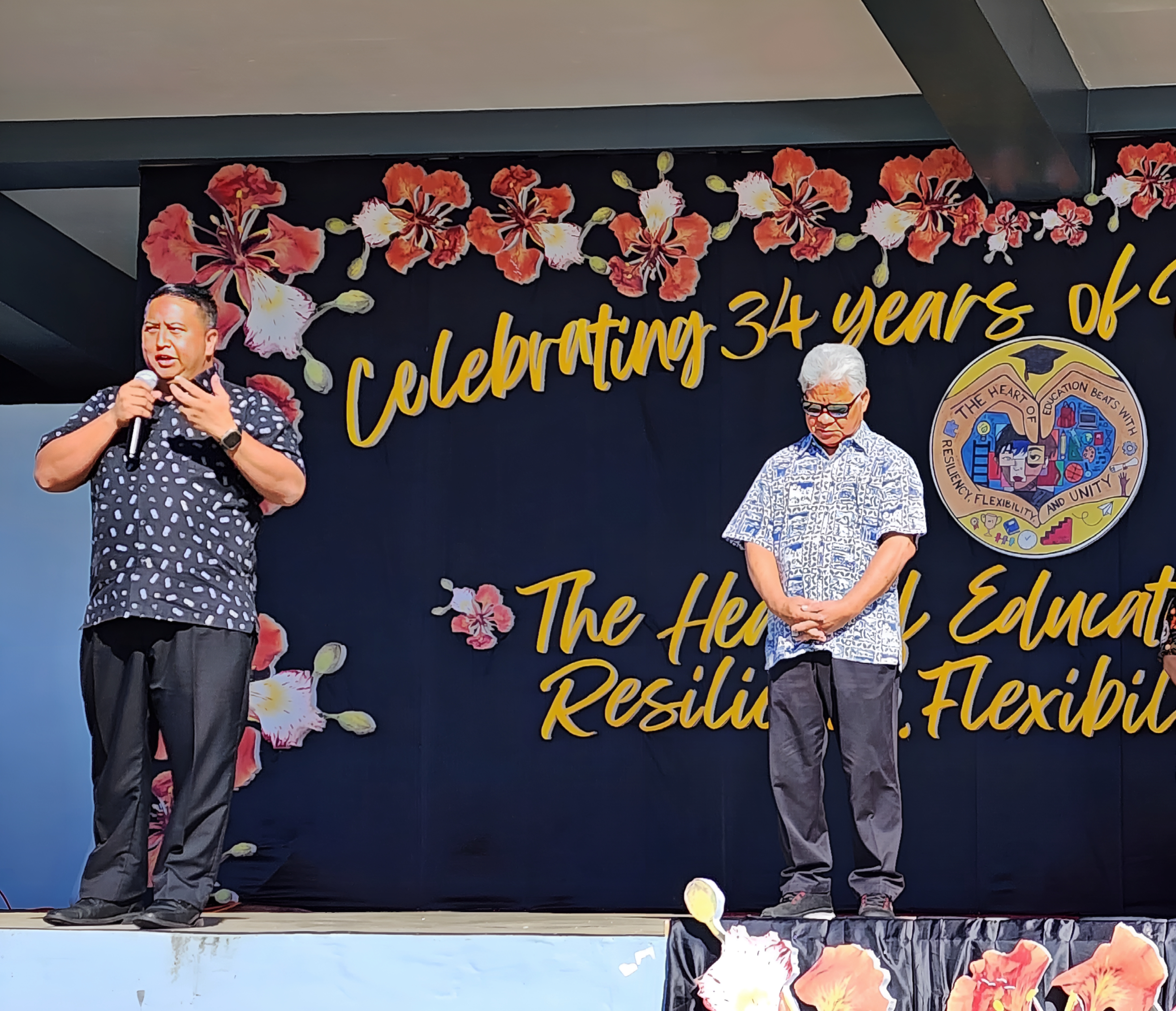 Gov. Ralph DLG Torres congratulates PSS during its 34th anniversary and Education Day celebration while Lt. Gov. Arnold I. Palacios listens.
