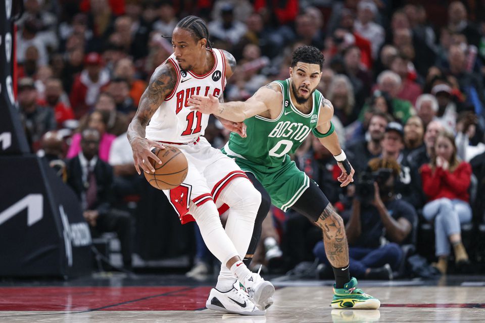 Chicago Bulls forward DeMar DeRozan (11) is defended by Boston Celtics forward Jayson Tatum (0) during the second half at United Center in Chicago, Illinois, Nov. 21, 2022.