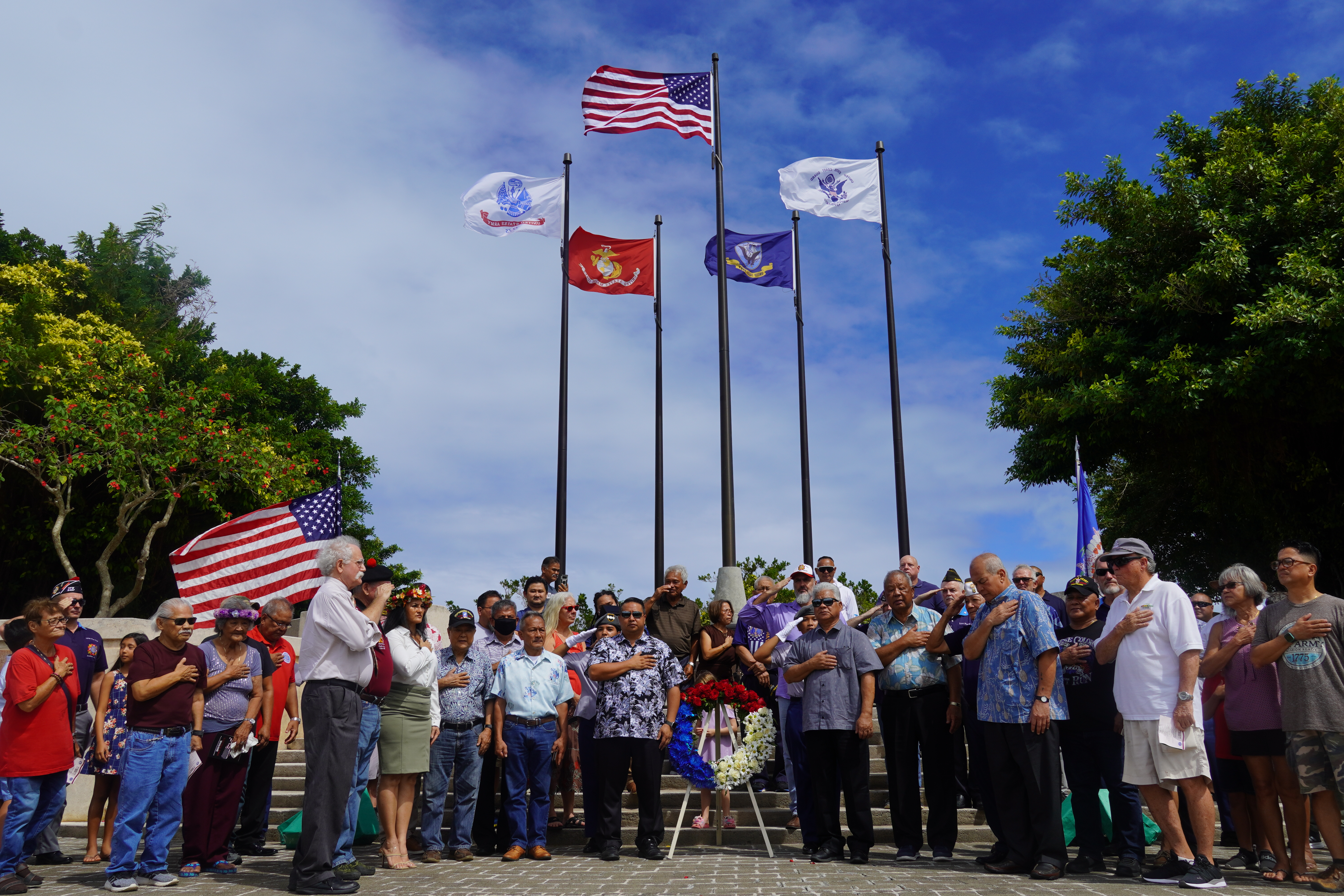 Government officials led by Gov. Ralph DLG Torres, veterans, family members and community members pay tribute to veterans on Friday after the ceremonial laying of the wreath at the American Memorial Park Court of Honor.