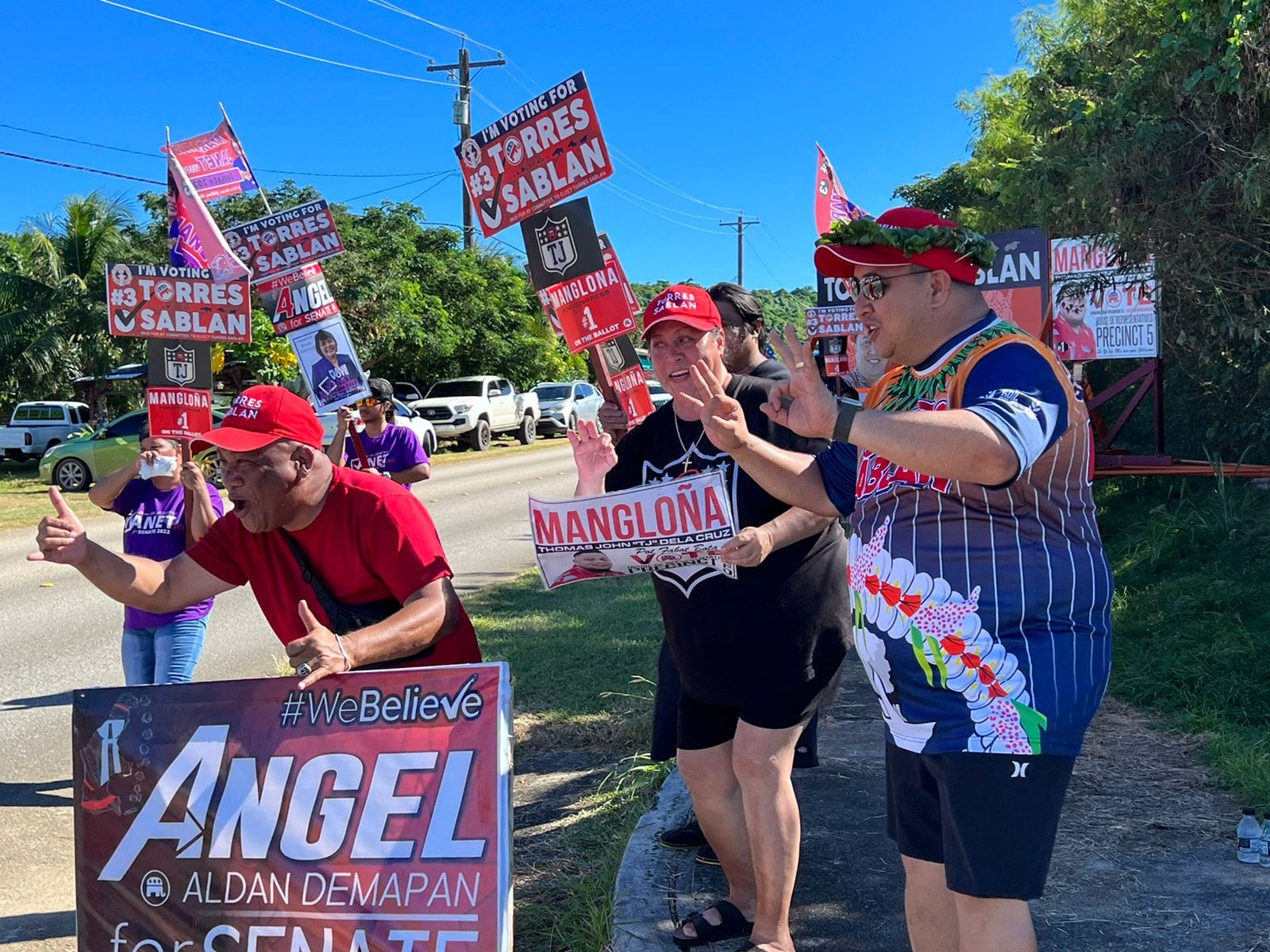 Gov. Ralph DLG Torres, right, and supporters greet motorists across from Chacha Oceanview Middle School in Kagman on Election Day, Tuesday.
