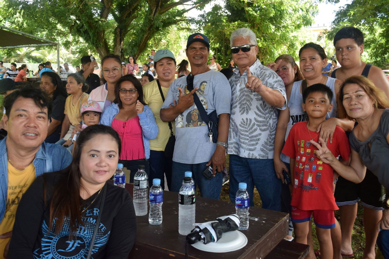 Independent gubernatorial candidate Lt. Gov. Arnold I. Palacios poses with Filipino community members at  Sugar King Park in Garapan on Saturday.
