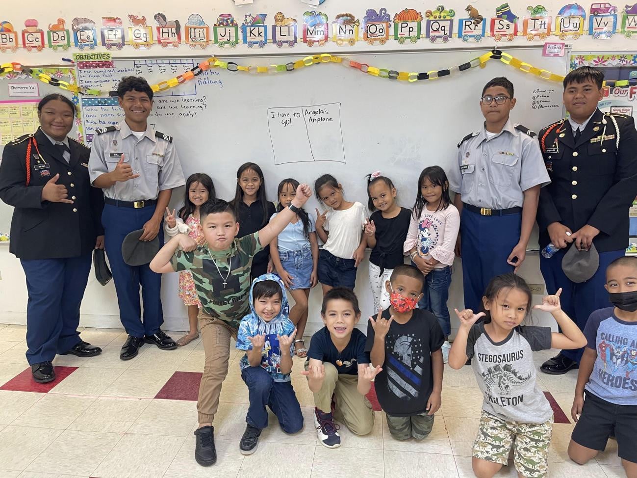 Kagman High School Ayuyu Battalion cadets pose for a photo with Kagman Elementary School students on Wednesday at KagES.