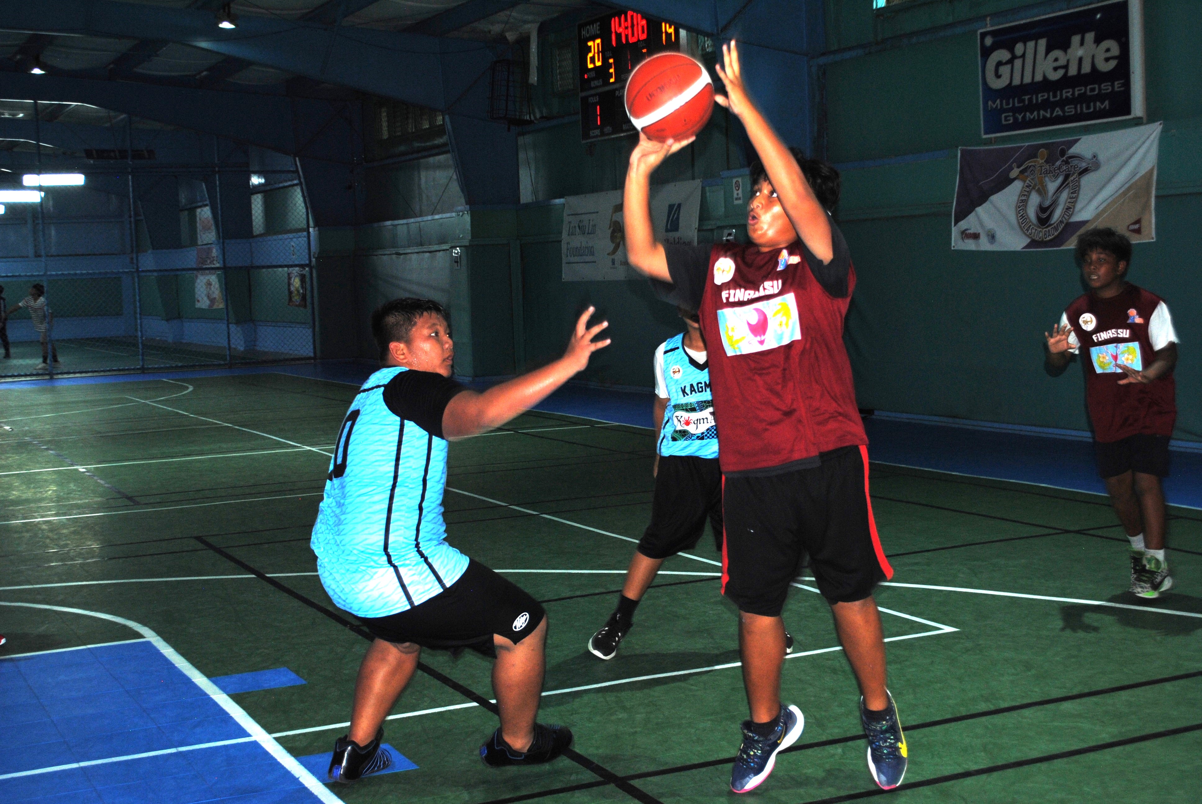 Finasisu's Marquix Hiroichi takes the shot over a defender during a U13 boys division game of the 2022 Marianas Village Pride Basketball League Saturday at the TSL Sports Complex.