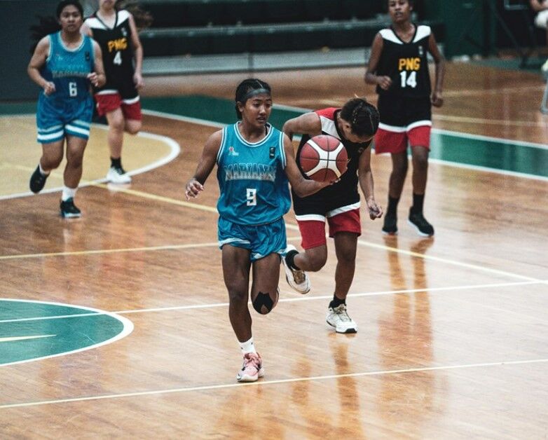The NMI's Kaithlyn Chavez dribbles past PNG defenders during a FIBA U15 Oceania Championships game Wednesday in Mangilao, Guam.
