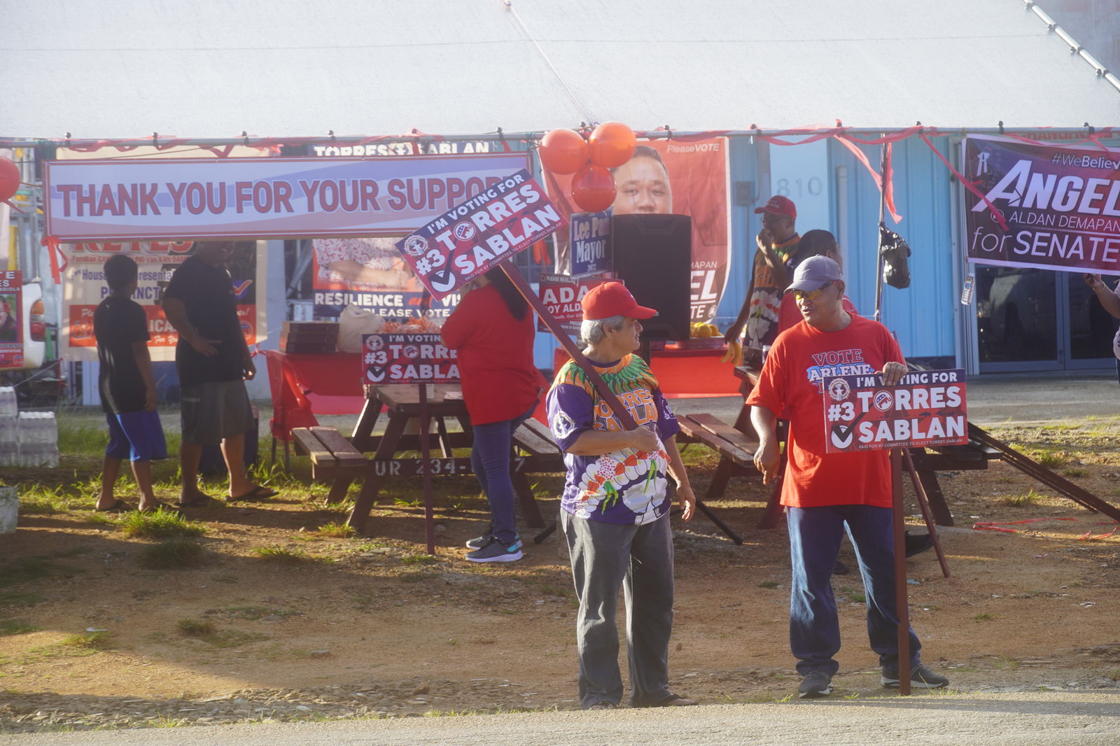 Republican supporters in Precinct 1 converse while waiting for motorists to pass by.