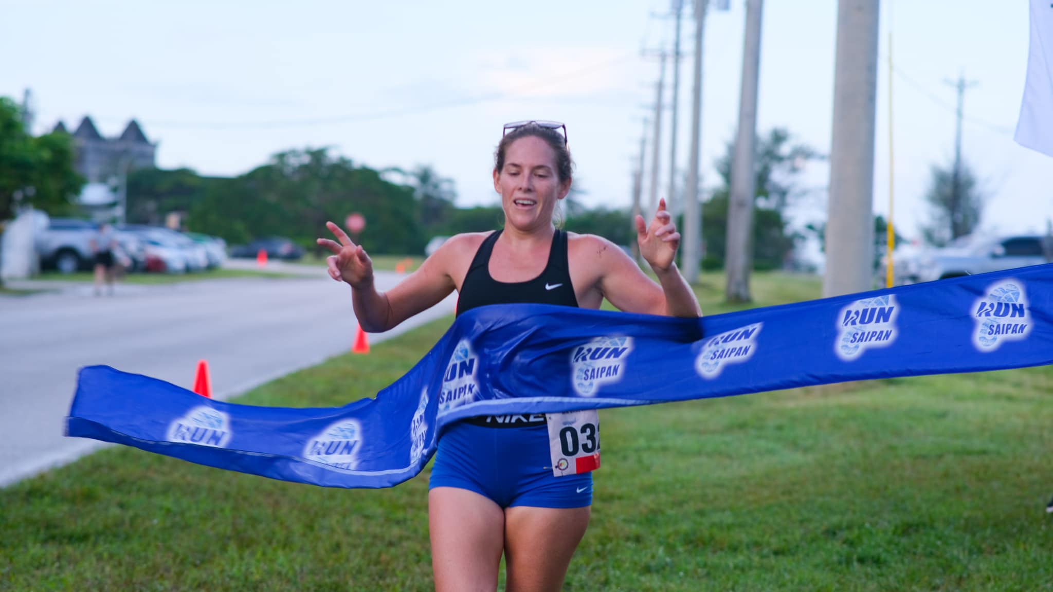 Denise Myers crosses the finish line of the Saipan International Airport Trail Run Saturday on Continental Road near United Air Cargo.