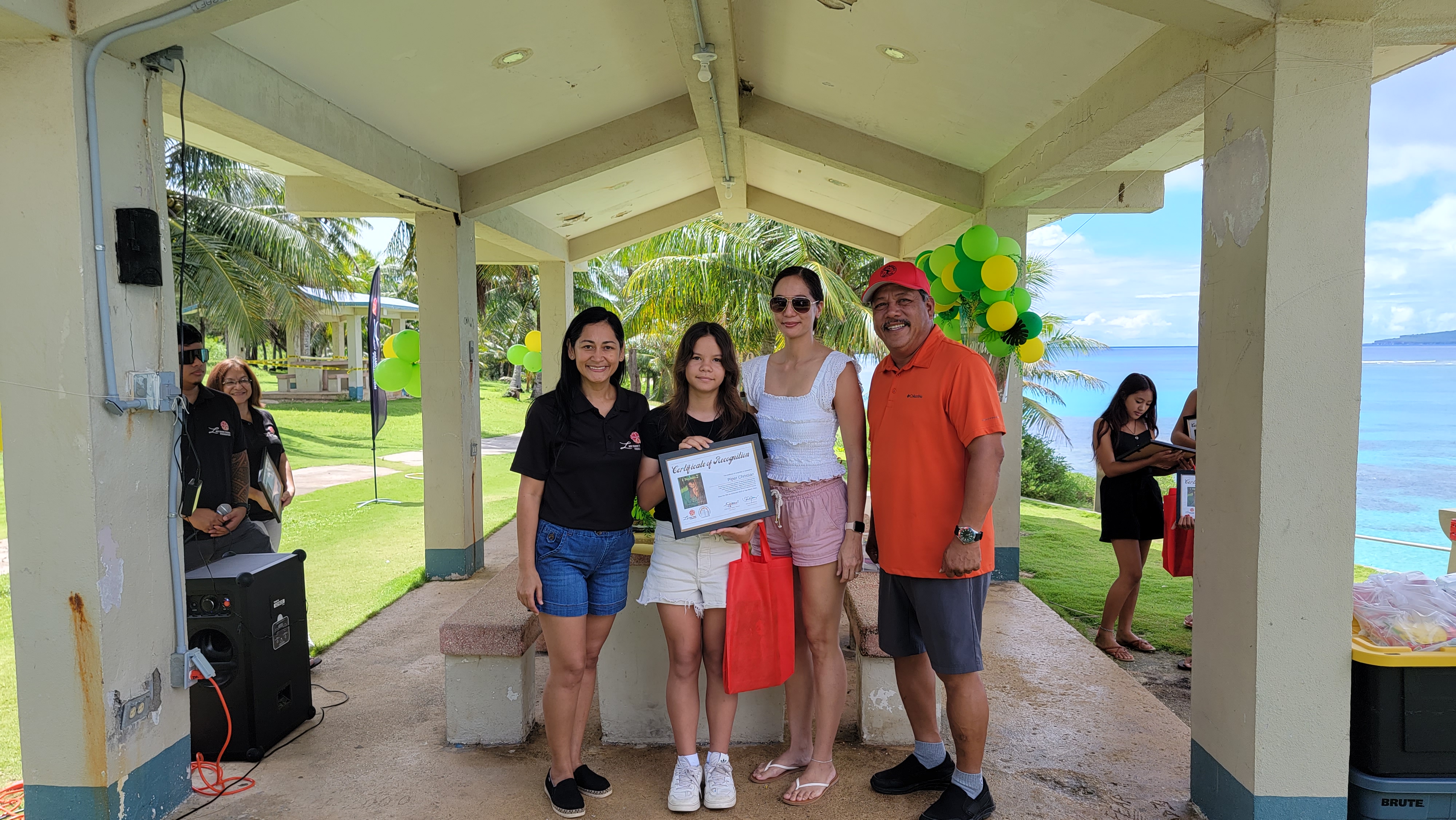 I Duendis 2 author Piper Christian receives her certificate of recognition from first lady Diann Torres. They are joined by Mayor Edwin Aldan and a family member.